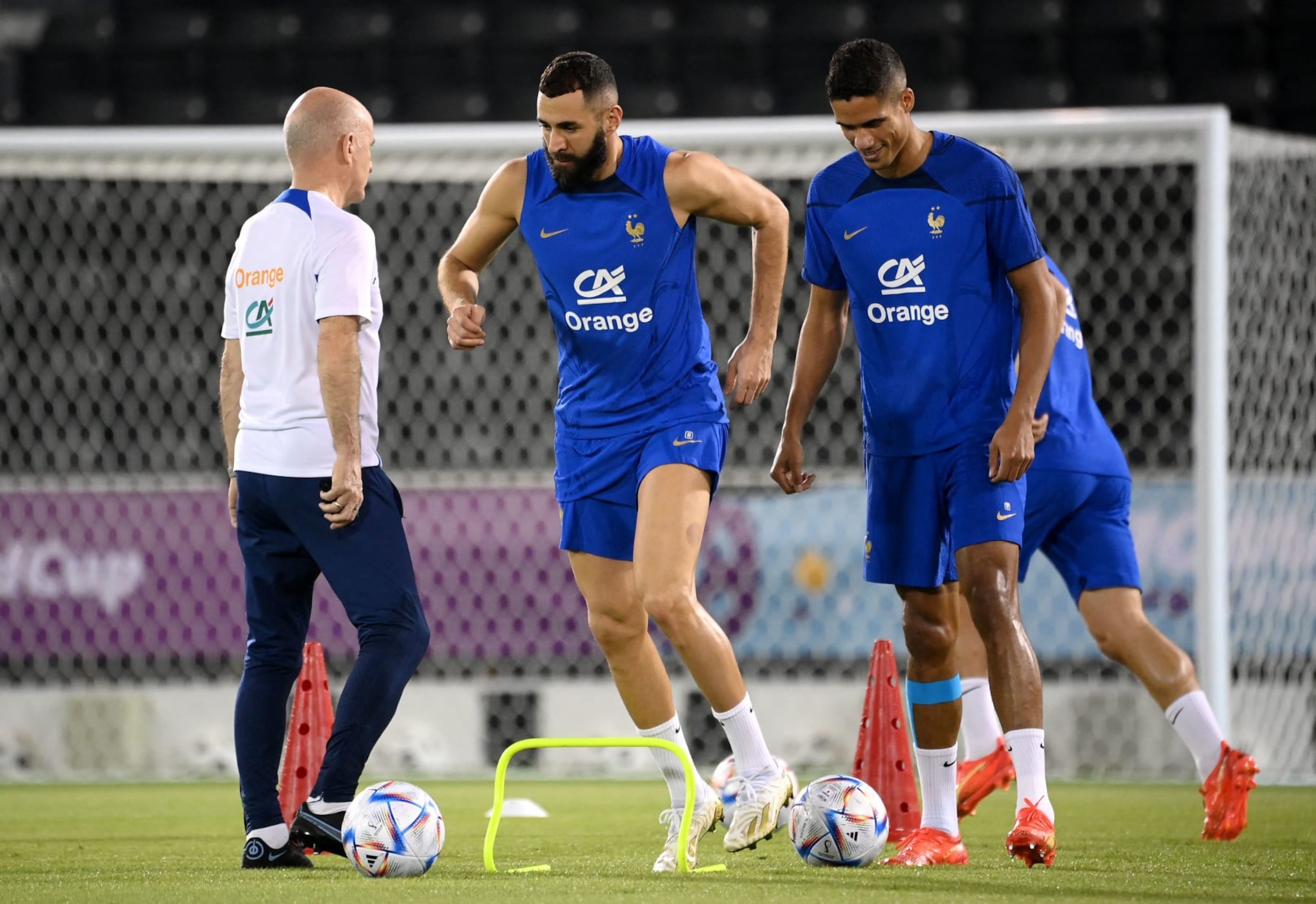 France's forward Karim Benzema (C) and France's defender Raphael Varane takes part in a training session next to France's assistant coach Guy Stephan (L) at the Jassim-bin-Hamad Stadium in Doha on November 19, 2022, ahead of the Qatar 2022 World Cup football tournament. (Photo by FRANCK FIFE / AFP) (Photo by FRANCK FIFE/AFP via Getty Images)
