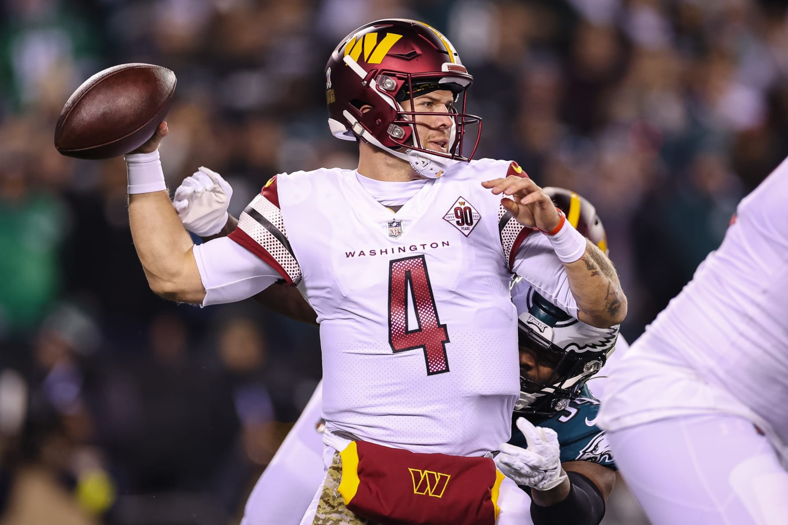 PHILADELPHIA, PA - NOVEMBER 14: Taylor Heinicke #4 of the Washington Commanders fumbles as he is sacked by Josh Sweat #94 of the Philadelphia Eagles during the first half at Lincoln Financial Field on November 14, 2022 in Philadelphia, Pennsylvania. (Photo by Scott Taetsch/Getty Images)