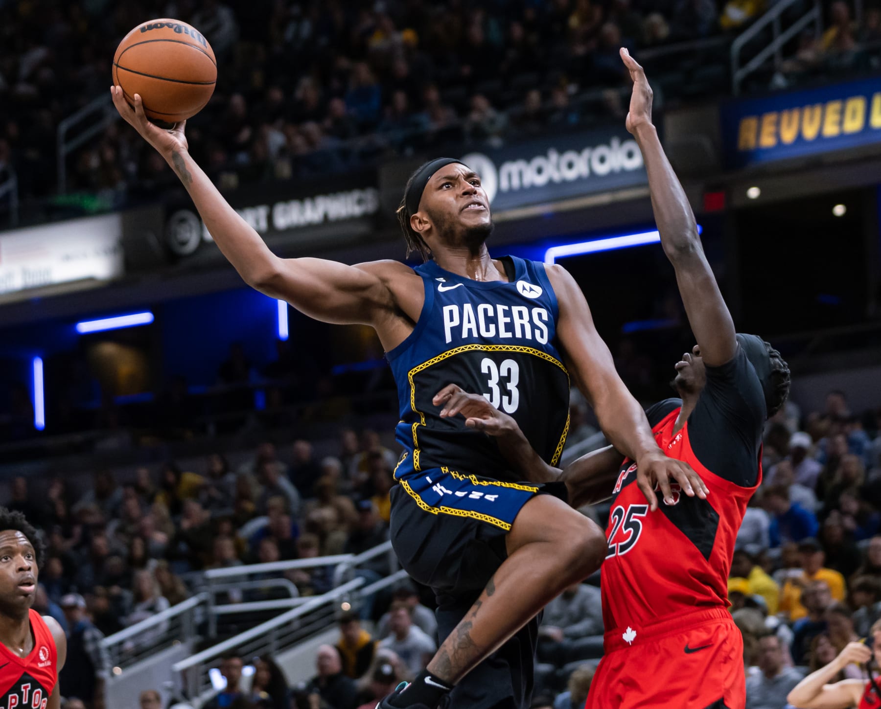 INDIANAPOLIS, IN - NOVEMBER 12: Myles Turner #33 of the Indiana Pacers shoots the ball against Chris Boucher #25 of the Toronto Raptors at Gainbridge Fieldhouse on November 12, 2022 in Indianapolis, Indiana. NOTE TO USER: User expressly acknowledges and agrees that, by downloading and or using this photograph, User is consenting to the terms and conditions of the Getty Images License Agreement.  (Photo by Michael Hickey/Getty Images)
