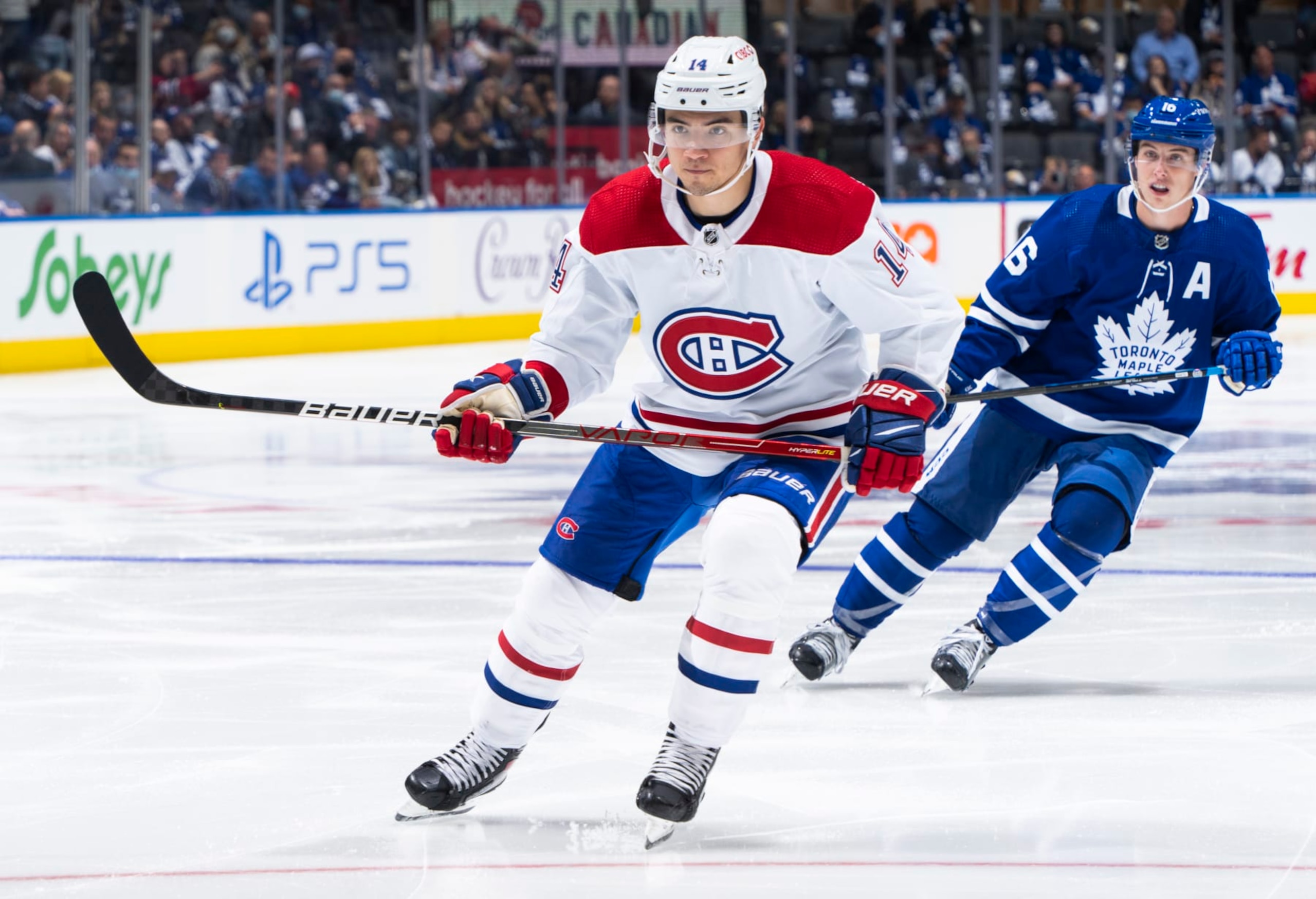 Montreal Canadiens center Nick Suzuki and Toronto Maple Leafs winger Mitch Marner. 
