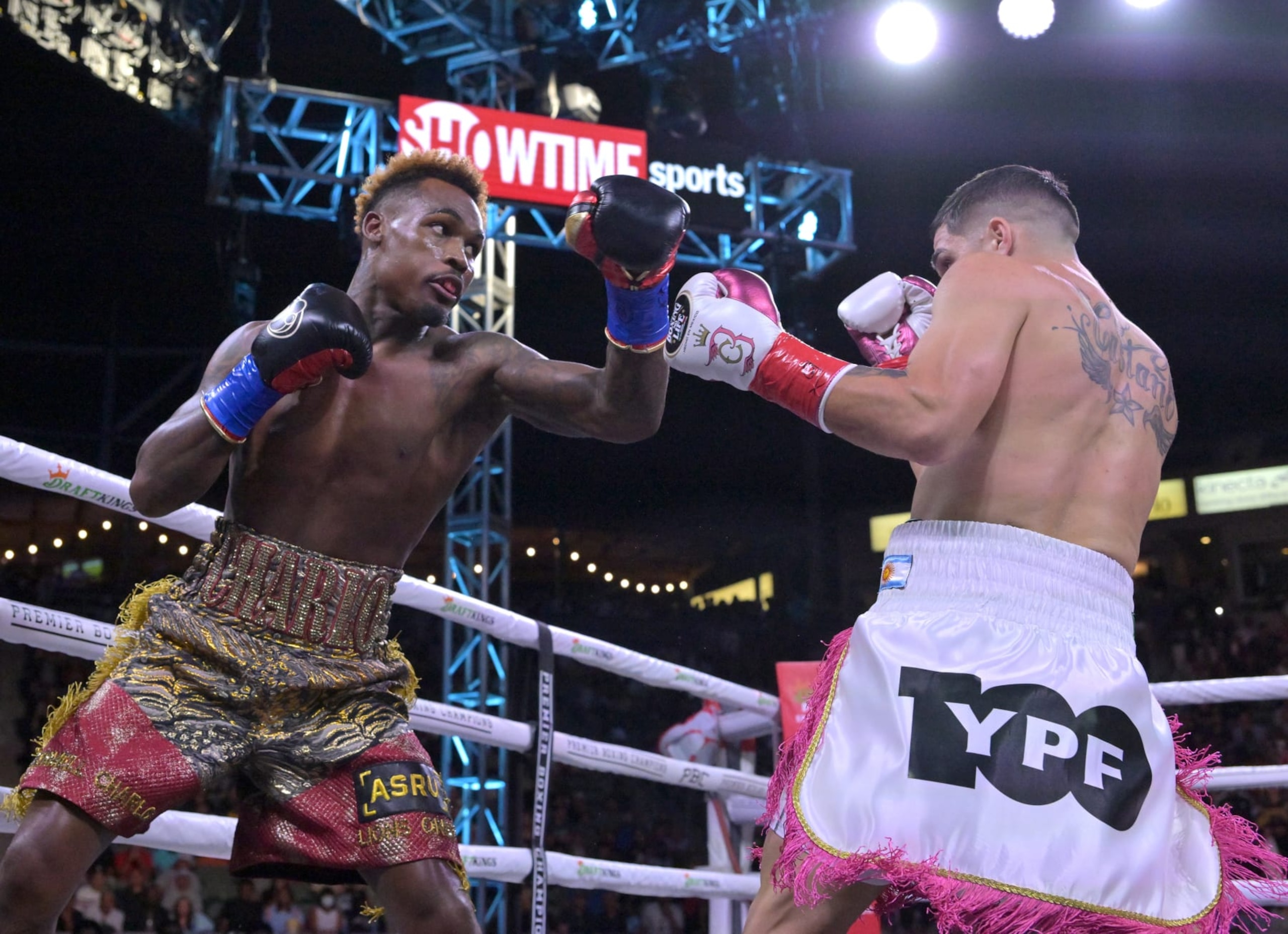 CARSON, CA - MAY 14: Jermell Charlo (gold/red shorts) exchanges punches in the ring with Brian Castano (white/pink shorts) during their super middleweight title fight at Dignity Health Sports Park on May 14, 2022 in Carson, California. Charlo won by knockout in the 10th round. (Photo by Jayne Kamin-Oncea/Getty Images) CARSON, CA - MAY 14: Jermell Charlo (gold/red shorts) exchanges punches in the ring with Brian Castano (white/pink shorts) during their super middleweight title fight at Dignity Health Sports Park on May 14, 2022 in Carson, California. Charlo won by knockout in the 10th round. (Photo by Jayne Kamin-Oncea/Getty Images)