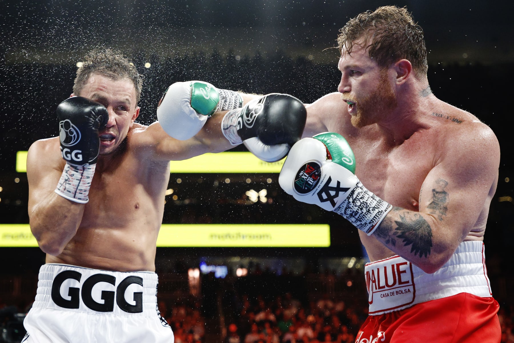LAS VEGAS, NEVADA - SEPTEMBER 17: Canelo Alvarez (red trunks) and Gennadiy Golovkin (white trunks) exchange punches in the fight for the Super Middleweight Title at T-Mobile Arena on September 17, 2022 in Las Vegas, Nevada. (Photo by Sarah Stier/Getty Images)