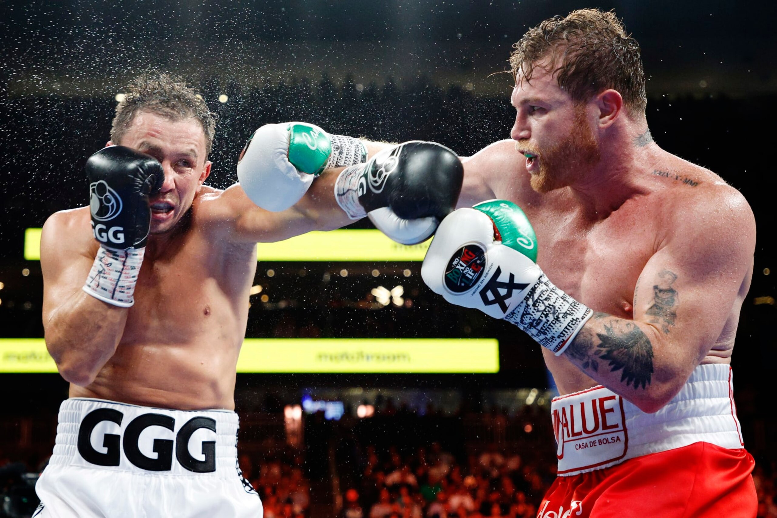 LAS VEGAS, NEVADA - SEPTEMBER 17: Canelo Alvarez (red trunks) and Gennadiy Golovkin (white trunks) exchange punches in the fight for the Super Middleweight Title at T-Mobile Arena on September 17, 2022 in Las Vegas, Nevada. (Photo by Sarah Stier/Getty Images) LAS VEGAS, NEVADA - SEPTEMBER 17: Canelo Alvarez (red trunks) and Gennadiy Golovkin (white trunks) exchange punches in the fight for the Super Middleweight Title at T-Mobile Arena on September 17, 2022 in Las Vegas, Nevada. (Photo by Sarah Stier/Getty Images)