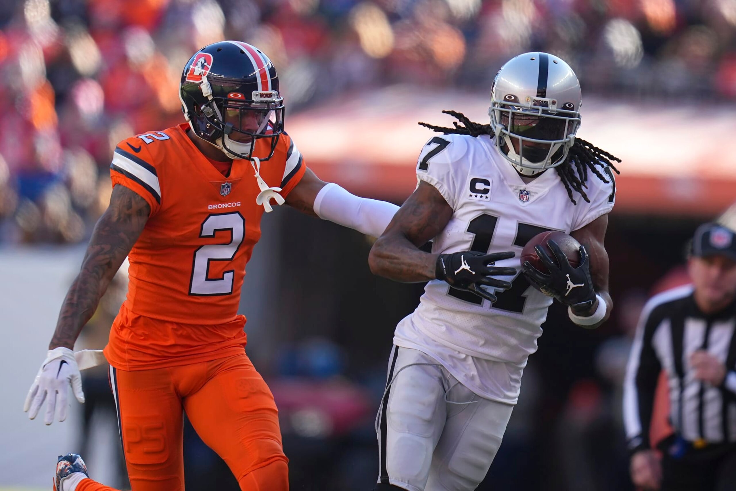 Las Vegas Raiders wide receiver Davante Adams (17) runs against Denver Broncos cornerback Pat Surtain II (2) during the first half of an NFL football game in Denver, Sunday, Nov. 20, 2022. (AP Photo/Jack Dempsey) Las Vegas Raiders wide receiver Davante Adams (17) runs against Denver Broncos cornerback Pat Surtain II (2) during the first half of an NFL football game in Denver, Sunday, Nov. 20, 2022. (AP Photo/Jack Dempsey)