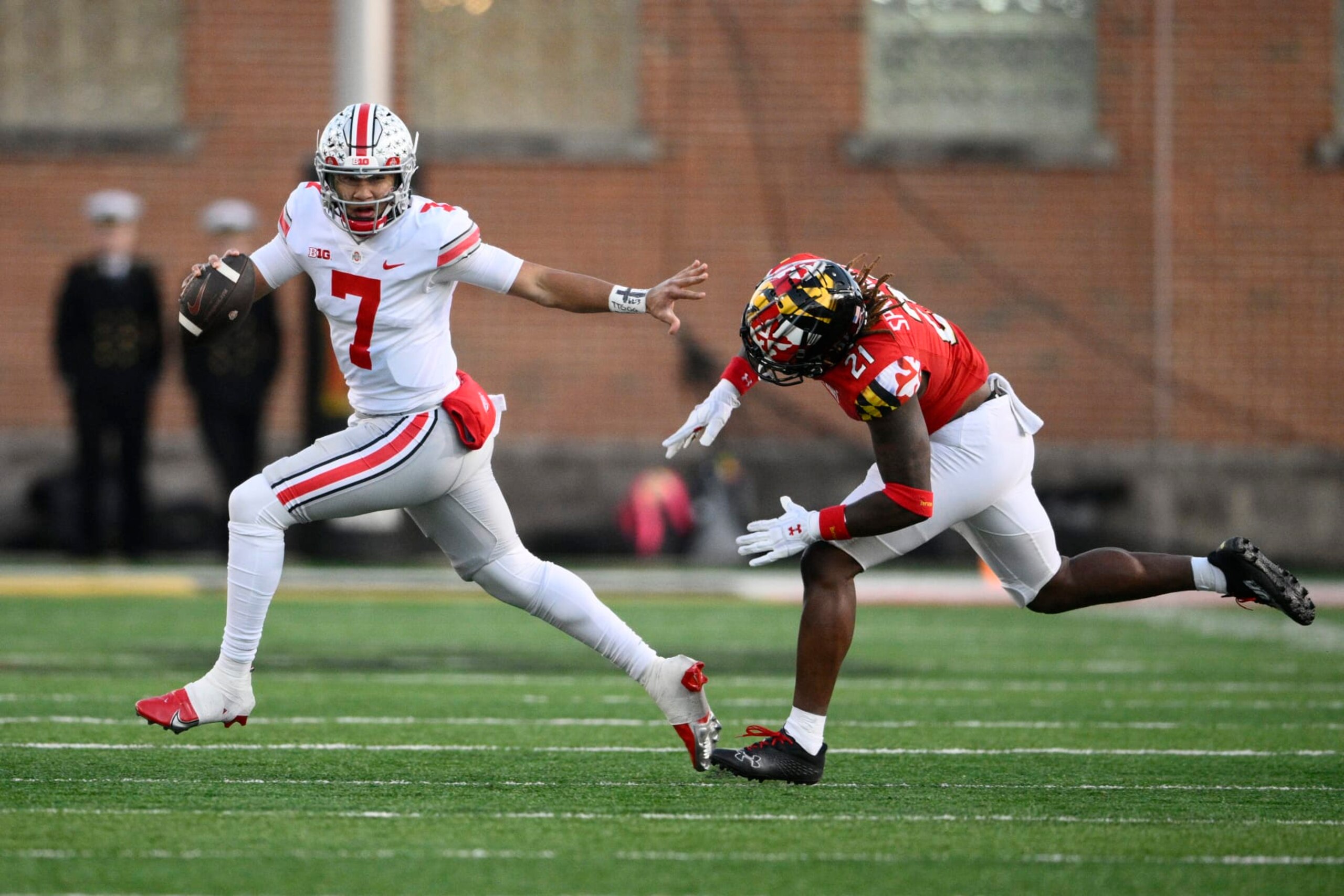 Ohio State quarterback C.J. Stroud (7) scrambles past Maryland linebacker Gereme Spraggins during the first half of an NCAA college football game, Saturday, Nov. 19, 2022, in College Park, Md. (AP Photo/Nick Wass)