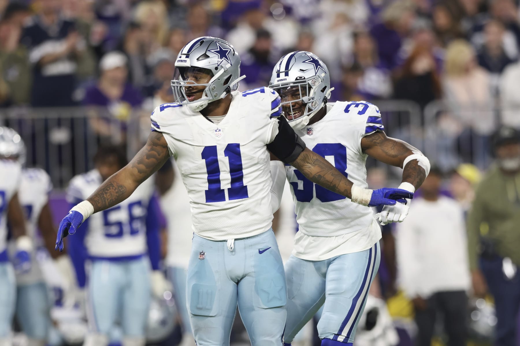 Dallas Cowboys linebackers Micah Parsons (11) and Damone Clark (33) react after Minnesota Vikings quarterback Kirk Cousins, not pictured, was sacked during the first half of an NFL football game Sunday, Nov. 20, 2022 in Minneapolis. (AP Photo/Stacy Bengs)