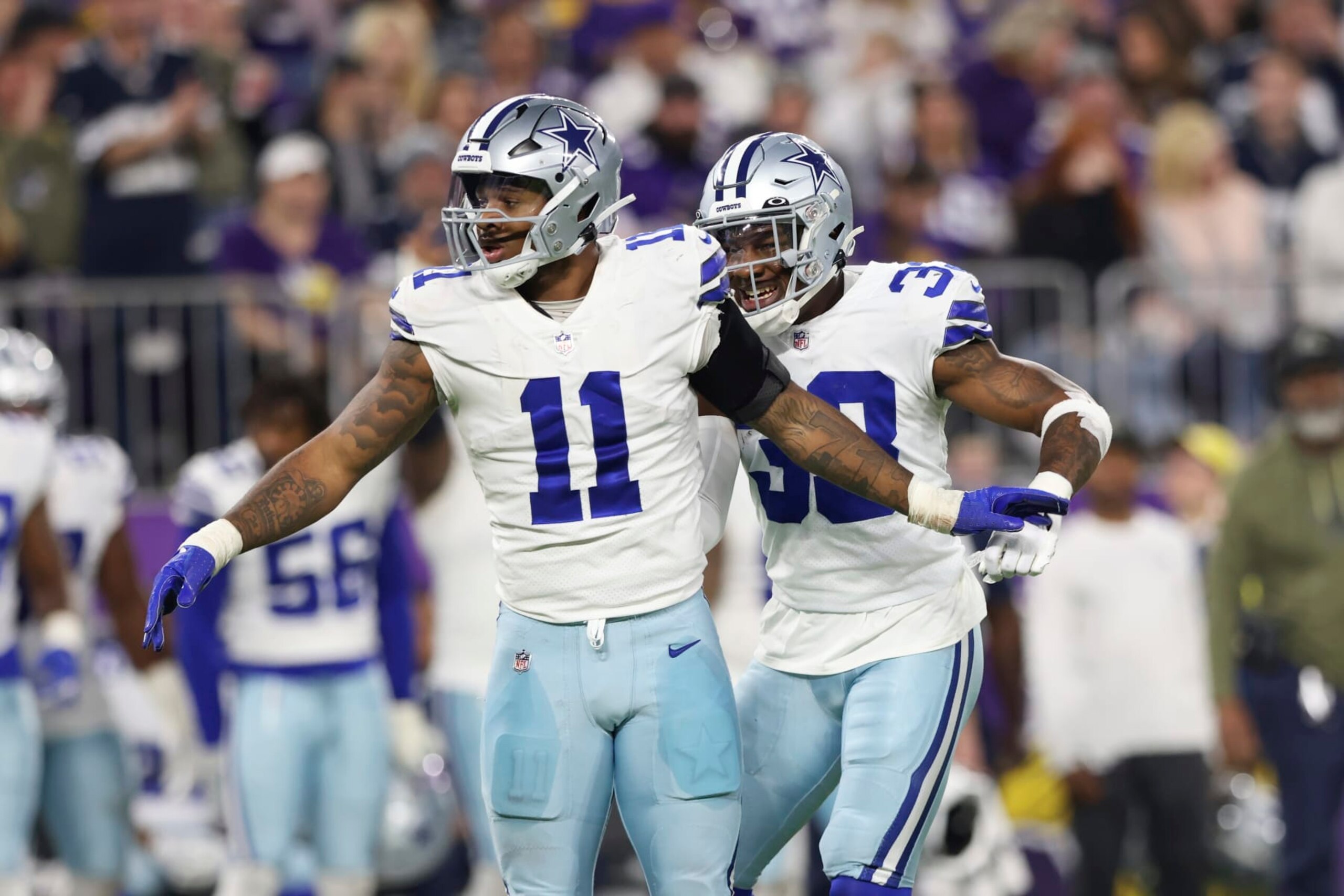 Dallas Cowboys linebackers Micah Parsons (11) and Damone Clark (33) react after Minnesota Vikings quarterback Kirk Cousins, not pictured, was sacked during the first half of an NFL football game Sunday, Nov. 20, 2022 in Minneapolis. (AP Photo/Stacy Bengs) Dallas Cowboys linebackers Micah Parsons (11) and Damone Clark (33) react after Minnesota Vikings quarterback Kirk Cousins, not pictured, was sacked during the first half of an NFL football game Sunday, Nov. 20, 2022 in Minneapolis. (AP Photo/Stacy Bengs)