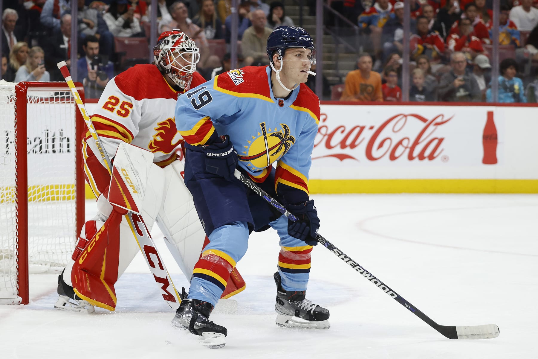 SUNRISE, FL - NOVEMBER 19: Matthew Tkachuk #19 of the Florida Panthers waits for a tip in attempt in front of goaltender Jacob Markstrom #25 of the Calgary Flames at the FLA Live Arena on November 19, 2022 in Sunrise, Florida. (Photo by Joel Auerbach/Getty Images)