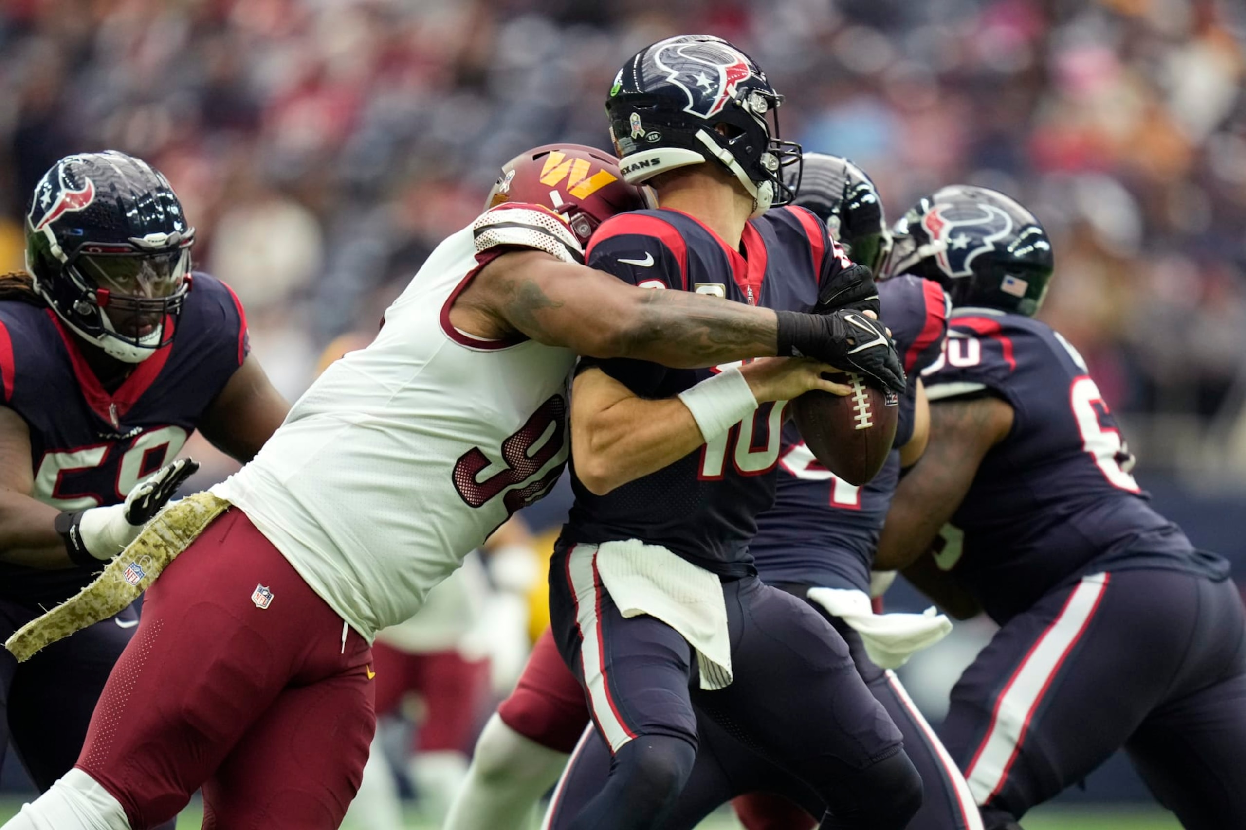 Houston Texans quarterback Davis Mills (10) is sacked by Washington Commanders defensive end Montez Sweat (90) during the first half of an NFL football game Sunday, Nov. 20, 2022, in Houston. (AP Photo/Eric Christian Smith) Houston Texans quarterback Davis Mills (10) is sacked by Washington Commanders defensive end Montez Sweat (90) during the first half of an NFL football game Sunday, Nov. 20, 2022, in Houston. (AP Photo/Eric Christian Smith)