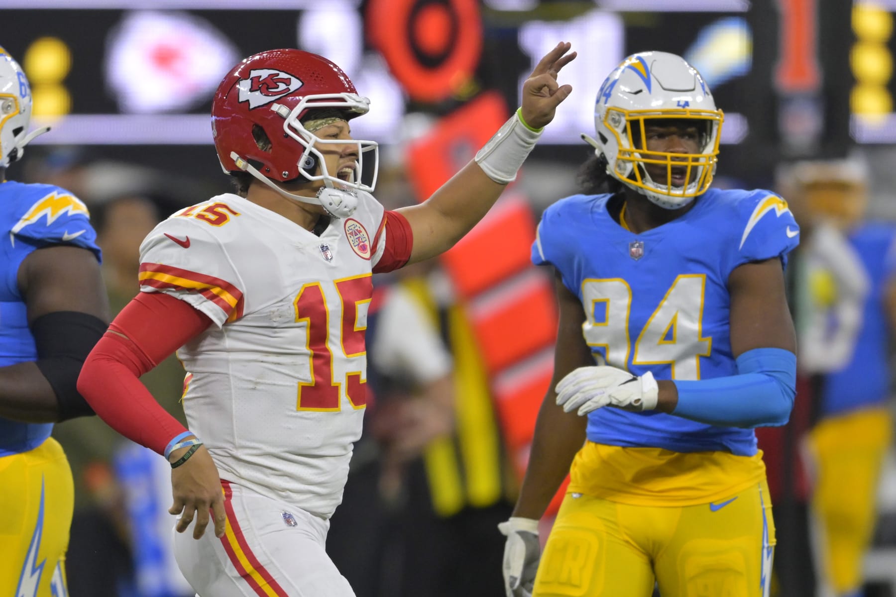 Kansas City Chiefs quarterback Patrick Mahomes, left, celebrates after running for a first down as Los Angeles Chargers linebacker Chris Rumph II stands in the background during the second half of an NFL football game Sunday, Nov. 20, 2022, in Inglewood, Calif. (AP Photo/Jayne Kamin-Oncea)