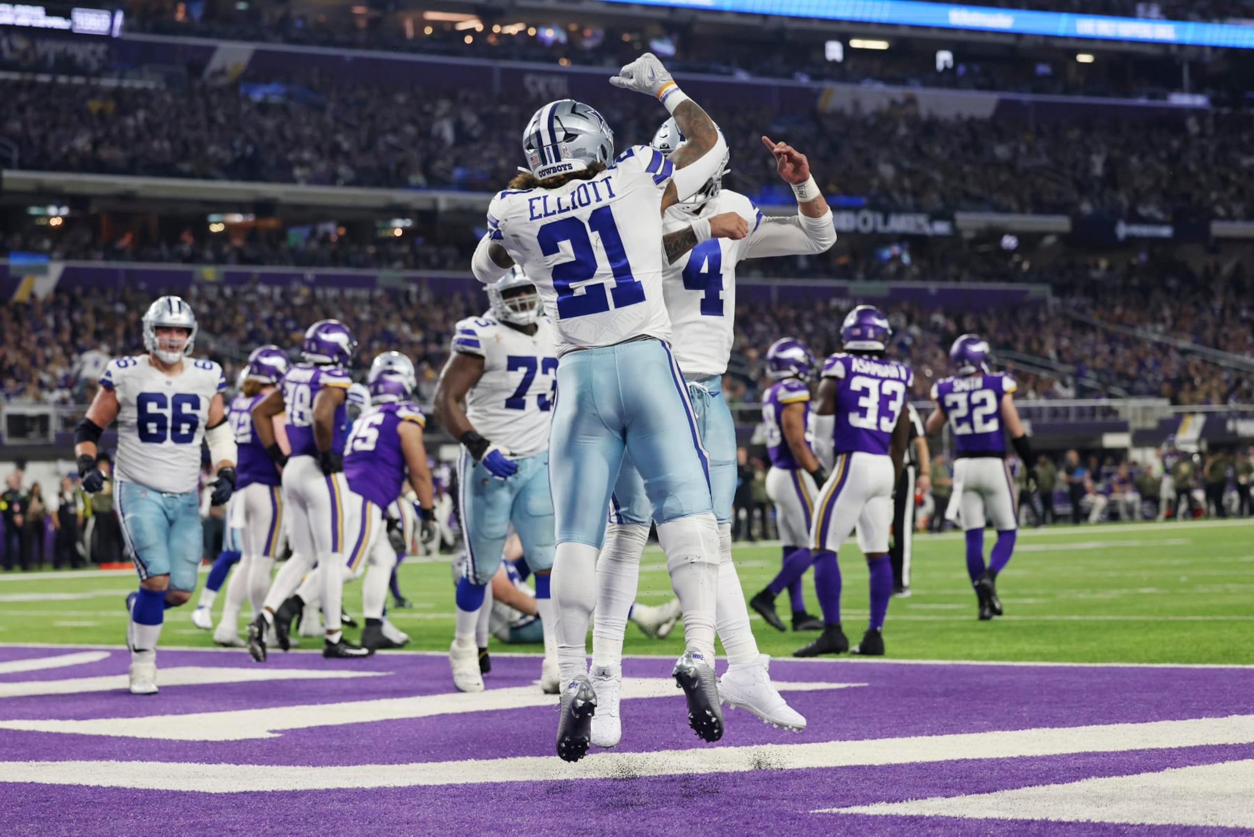 Dallas Cowboys running back Ezekiel Elliott (21) celebrates with quarterback Dak Prescott (4) after scoring a touchdown during the second half of an NFL football game Sunday, Nov. 20, 2022 in Minneapolis. (AP Photo/Stacy Bengs) Dallas Cowboys running back Ezekiel Elliott (21) celebrates with quarterback Dak Prescott (4) after scoring a touchdown during the second half of an NFL football game Sunday, Nov. 20, 2022 in Minneapolis. (AP Photo/Stacy Bengs)