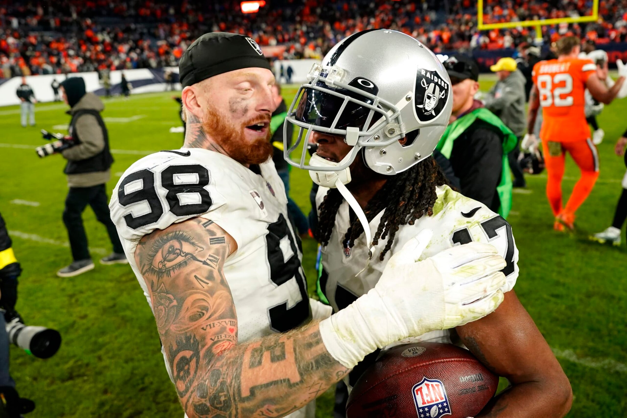 Las Vegas Raiders defensive end Maxx Crosby (98) celebrates wide receiver Davante Adams (17) after an NFL football game against the Denver Broncos in Denver, Sunday, Nov. 20, 2022. The Raiders won 22-16 in overtime. (AP Photo/Jack Dempsey) Las Vegas Raiders defensive end Maxx Crosby (98) celebrates wide receiver Davante Adams (17) after an NFL football game against the Denver Broncos in Denver, Sunday, Nov. 20, 2022. The Raiders won 22-16 in overtime. (AP Photo/Jack Dempsey)