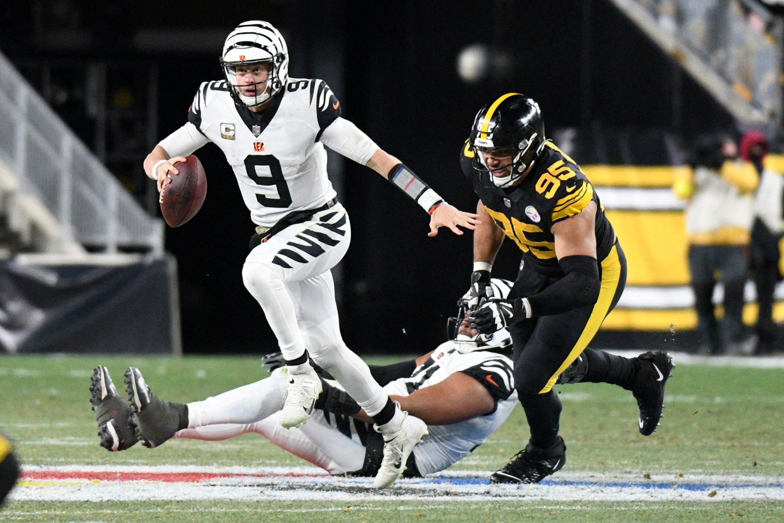Cincinnati Bengals quarterback Joe Burrow (9) eludes Pittsburgh Steelers defensive tackle Chris Wormley (95) during the second half of an NFL football game, Sunday, Nov. 20, 2022, in Pittsburgh. (AP Photo/Don Wright) Cincinnati Bengals quarterback Joe Burrow (9) eludes Pittsburgh Steelers defensive tackle Chris Wormley (95) during the second half of an NFL football game, Sunday, Nov. 20, 2022, in Pittsburgh. (AP Photo/Don Wright)