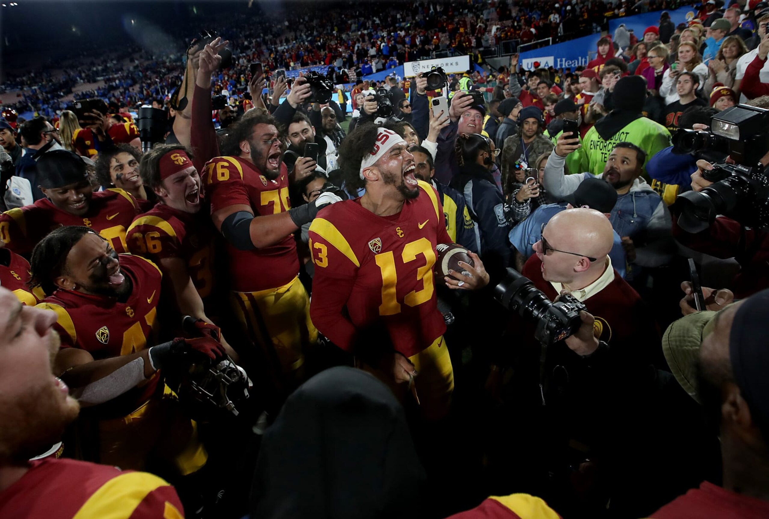 PASADENA, CALIF., NOV 19, 2022. USC quaarterback Caleb Williams, center, celebrates with teammates after the Trojans defeated the UCLA Bruins in the annual crosstown rivalry game, played at the Rose Bowl in Pasadena on Saturday night, Nov. 19, 2022. (Luis Sinco / Los Angeles Times via Getty Images)