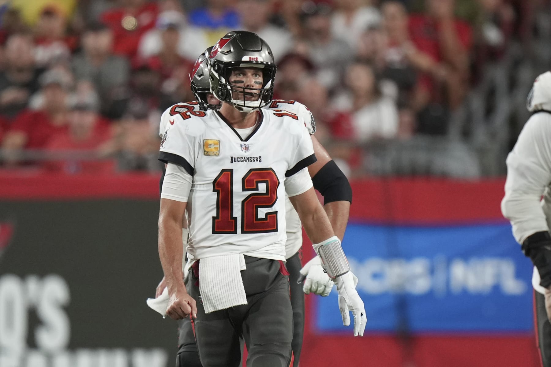 Tampa Bay Buccaneers quarterback Tom Brady (12) watches the play unfold after his completion to pass 100,000 yards passing during an NFL football game against the Los Angeles Rams, Sunday, Nov. 1, 2022 in Tampa, Fla. The Buccaneers defeat the Rams 16-13. (AP Photo/Peter Joneleit)