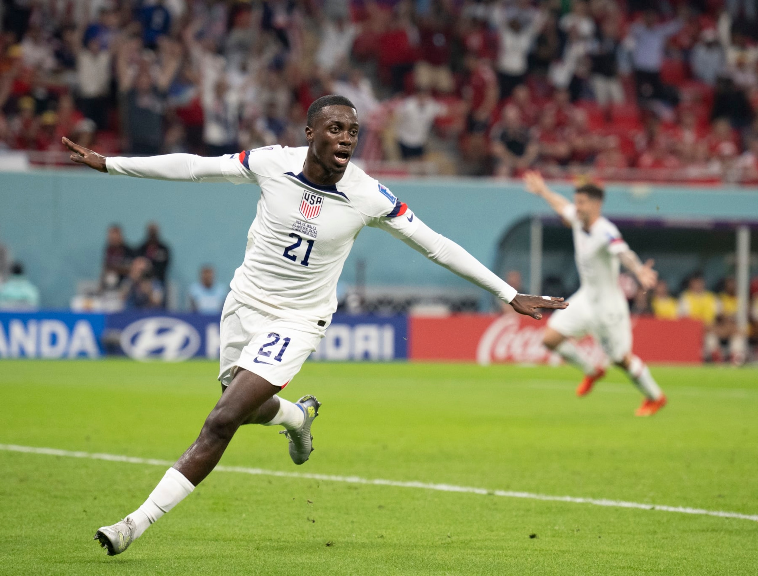 DOHA, QATAR - NOVEMBER 21: Timothy Weah celebrates after scoring the United States first goal during the FIFA World Cup Qatar 2022 Group B match between USA and Wales at Ahmad Bin Ali Stadium on November 21, 2022 in Doha, Qatar. (Photo by Sebastian Frej/MB Media/Getty Images)