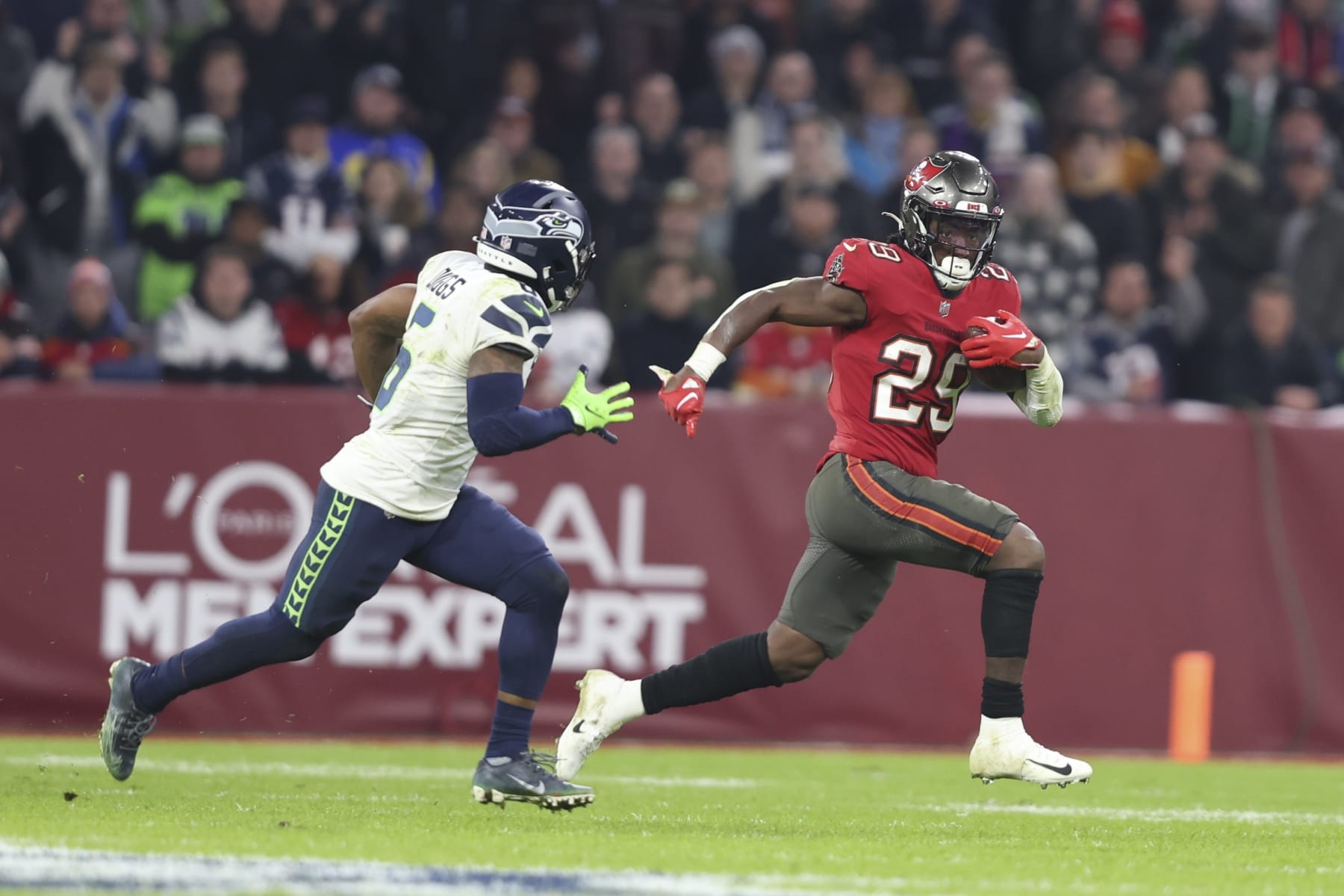 Tampa Bay Buccaneers' Rachaad White (29) runs against Seattle Seahawks' Quandre Diggs (6) during the second half of an NFL football game, Sunday, Nov. 13, 2022, in Munich, Germany. (AP Photo/Gary McCullough)