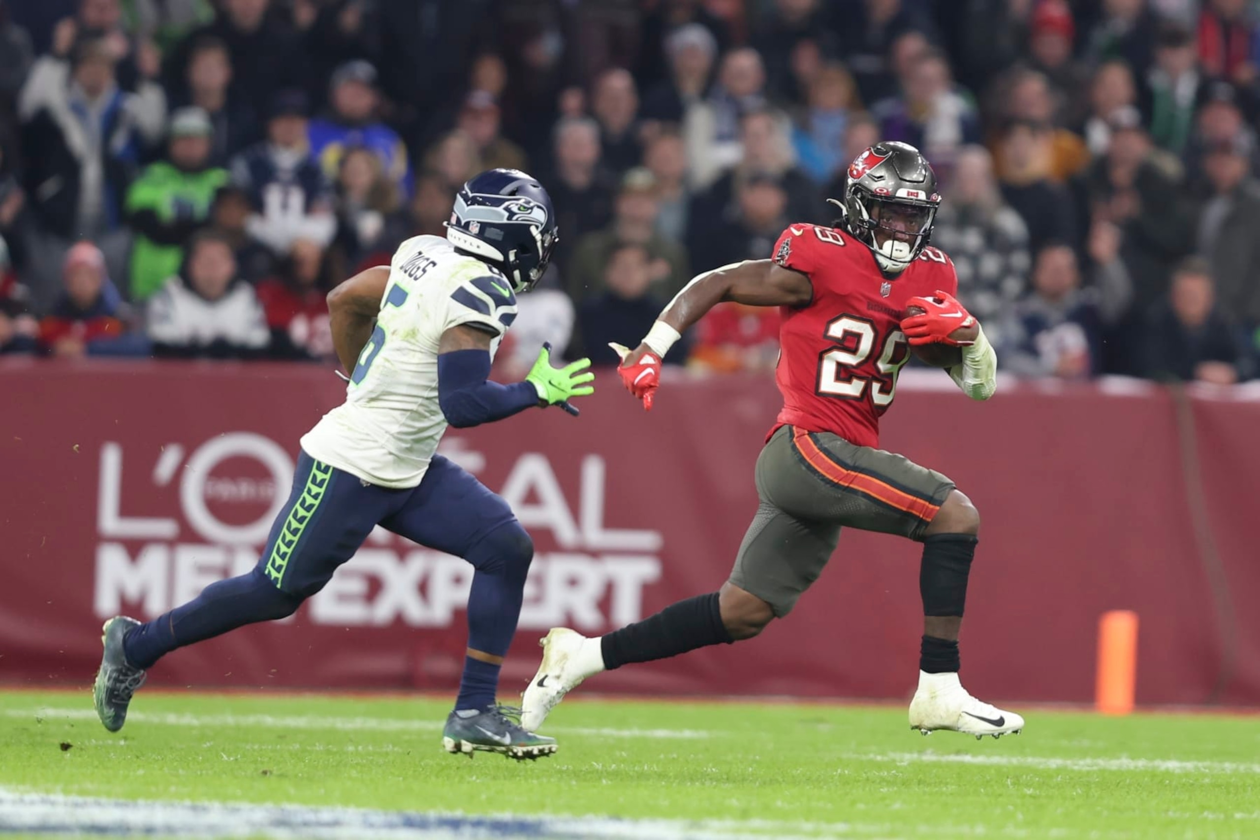 Tampa Bay Buccaneers' Rachaad White (29) runs against Seattle Seahawks' Quandre Diggs (6) during the second half of an NFL football game, Sunday, Nov. 13, 2022, in Munich, Germany. (AP Photo/Gary McCullough) Tampa Bay Buccaneers' Rachaad White (29) runs against Seattle Seahawks' Quandre Diggs (6) during the second half of an NFL football game, Sunday, Nov. 13, 2022, in Munich, Germany. (AP Photo/Gary McCullough)