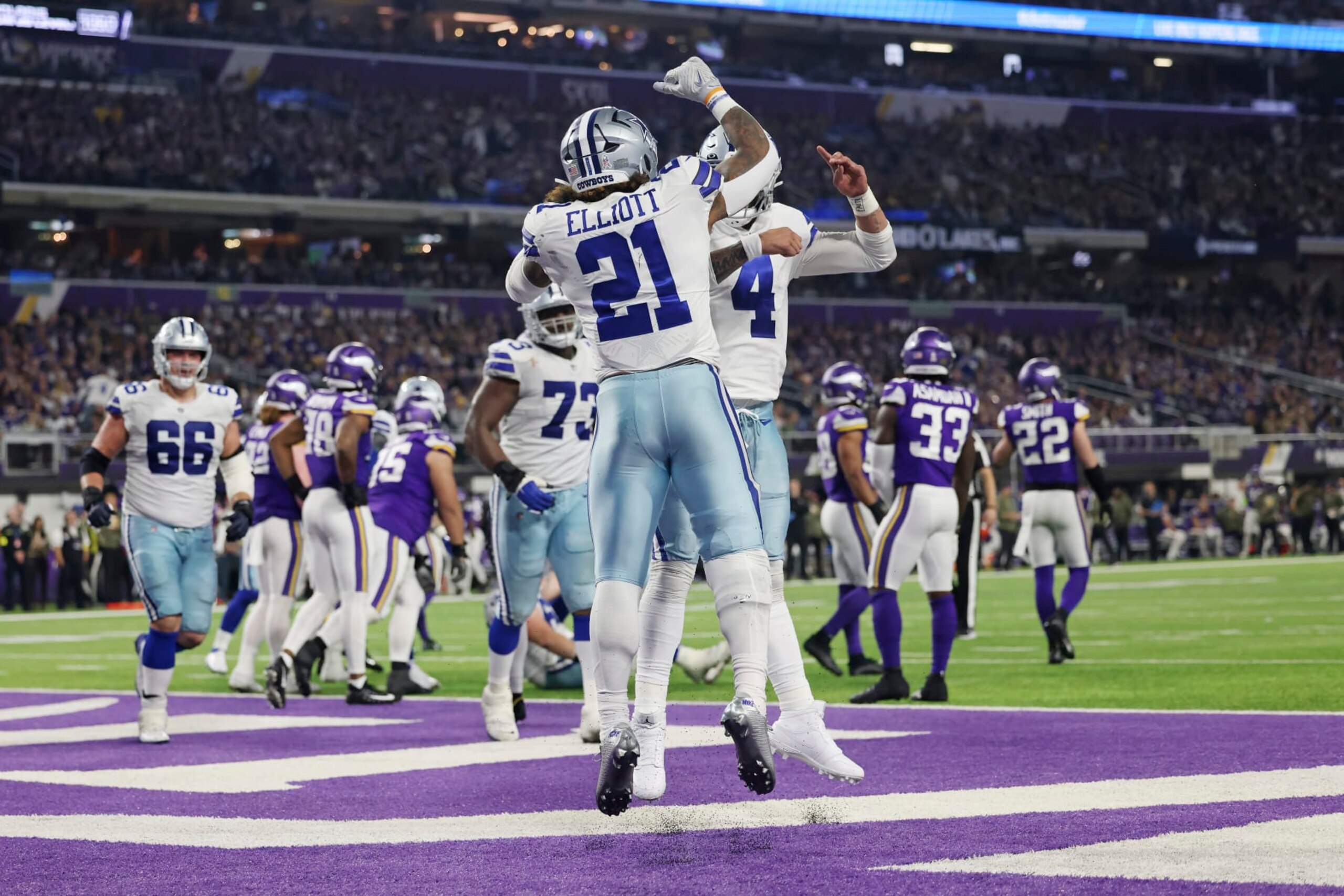 Dallas Cowboys running back Ezekiel Elliott (21) celebrates with quarterback Dak Prescott (4) after scoring a touchdown during the second half of an NFL football game Sunday, Nov. 20, 2022 in Minneapolis. (AP Photo/Stacy Bengs)