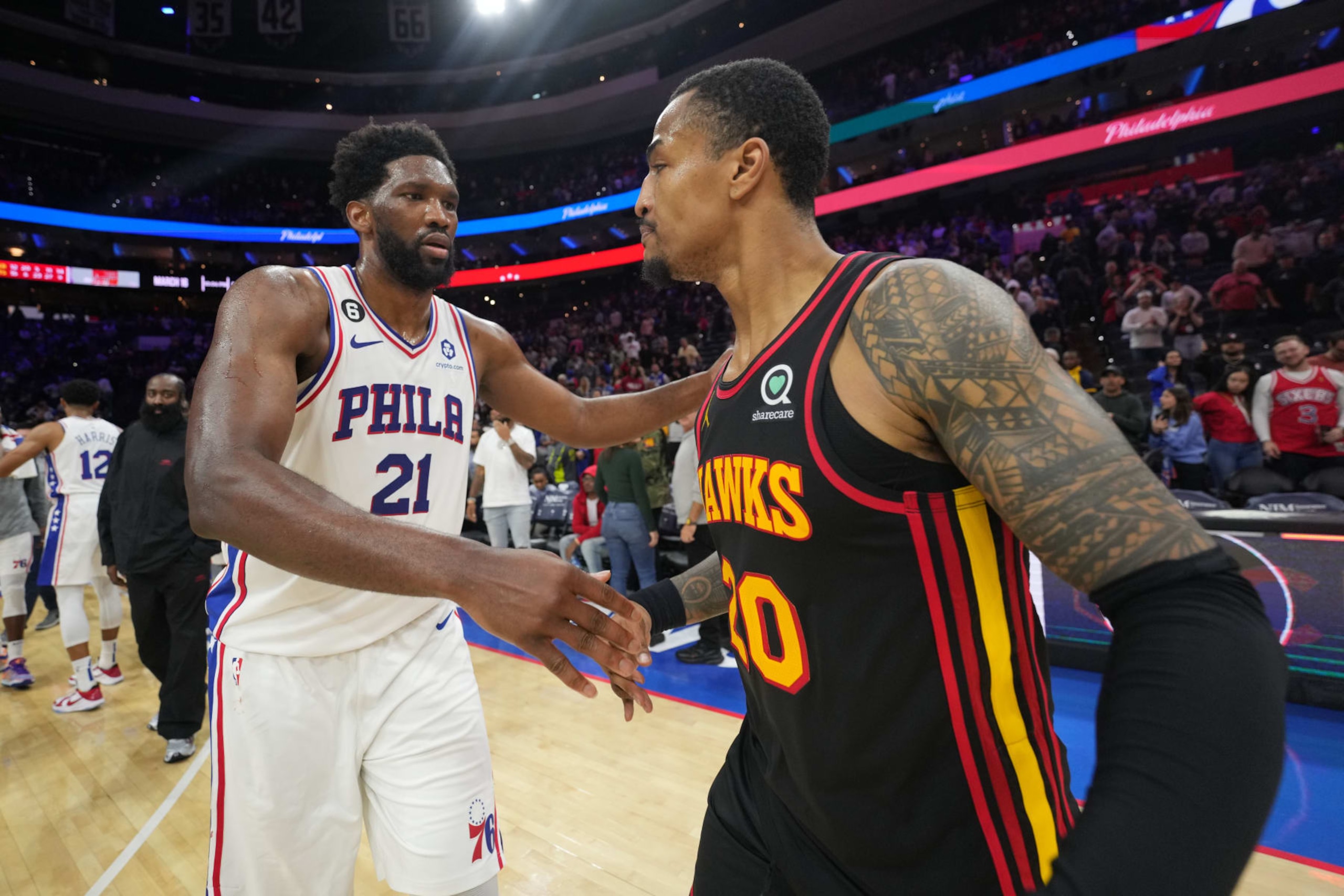 PHILADELPHIA, PA - NOVEMBER 12: Joel Embiid #21 of the Philadelphia 76ers hugs John Collins #20 of the Atlanta Hawks after the game on November 12, 2022 at the Wells Fargo Center in Philadelphia, Pennsylvania NOTE TO USER: User expressly acknowledges and agrees that, by downloading and/or using this Photograph, user is consenting to the terms and conditions of the Getty Images License Agreement. Mandatory Copyright Notice: Copyright 2022 NBAE (Photo by Jesse D. Garrabrant/NBAE via Getty Images)
