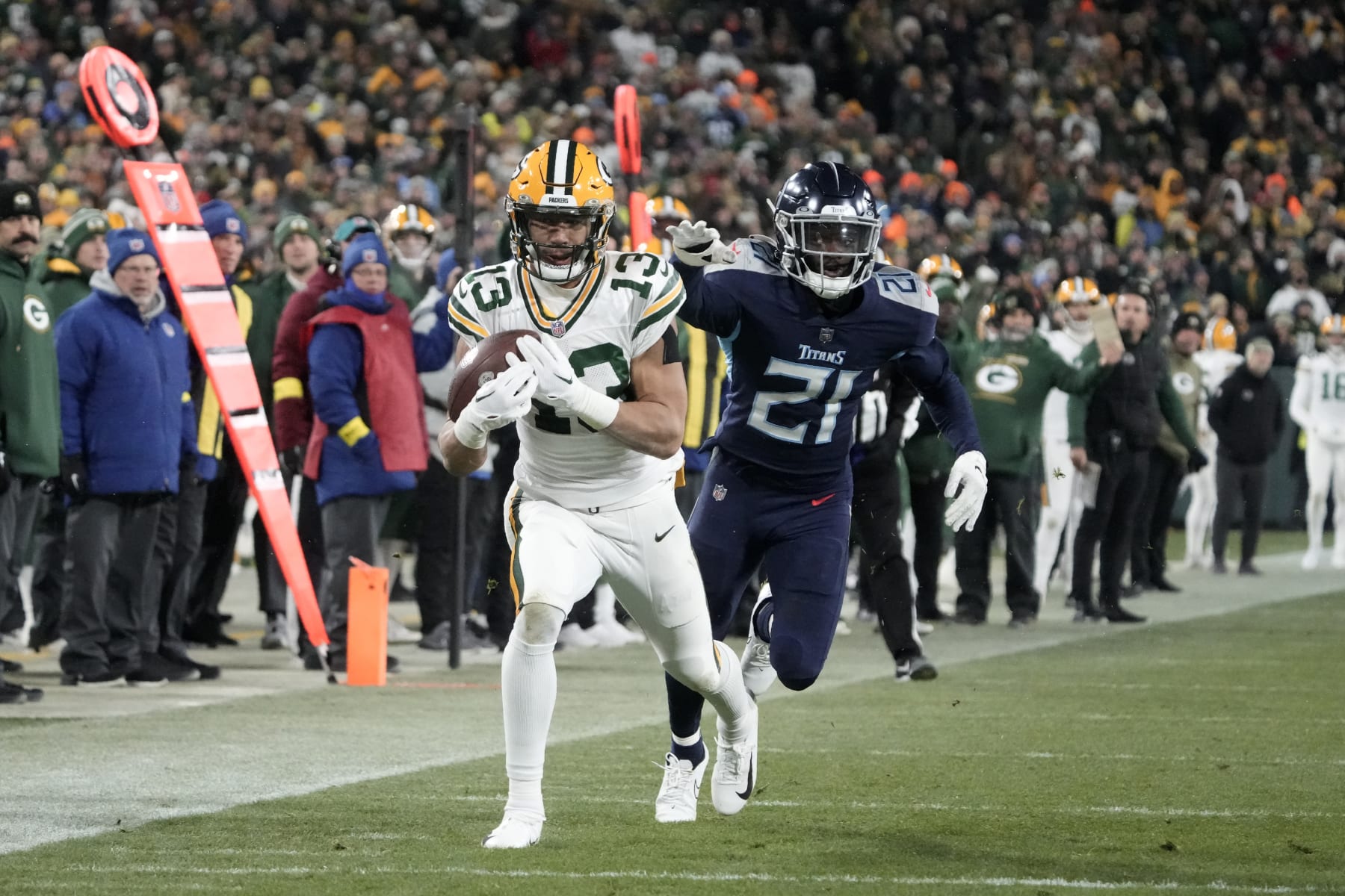 Green Bay Packers wide receiver Allen Lazard (13) catches a pass as Tennessee Titans cornerback Roger McCreary (21) defends during the second half of an NFL football game Thursday, Nov. 17, 2022, in Green Bay, Wis. (AP Photo/Morry Gash)
