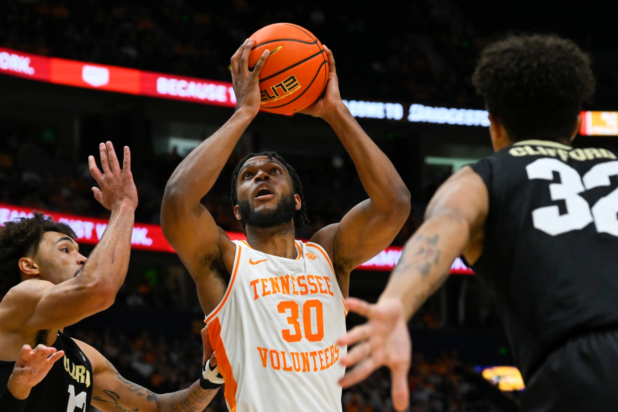 Tennessee guard Josiah-Jordan James (30) shoots as Colorado guard J'Vonne Hadley, left, and Colorado guard Nique Clifford, right, defend during the first half of an NCAA college basketball game, Sunday, Nov. 13, 2022, in Nashville, Tenn. (AP Photo/John Amis) Tennessee guard Josiah-Jordan James (30) shoots as Colorado guard J'Vonne Hadley, left, and Colorado guard Nique Clifford, right, defend during the first half of an NCAA college basketball game, Sunday, Nov. 13, 2022, in Nashville, Tenn. (AP Photo/John Amis)