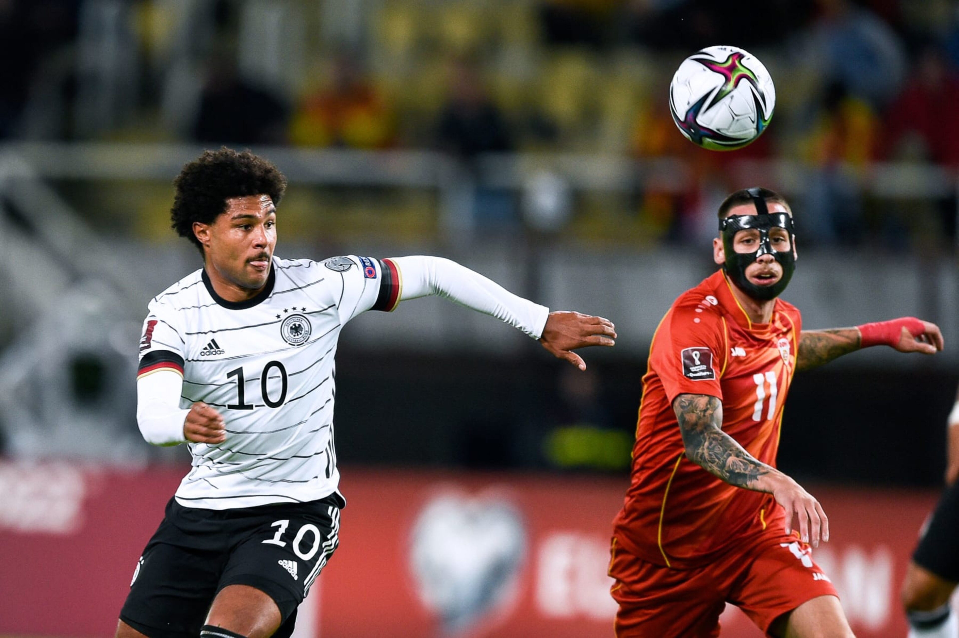 Germany's midfielder Serge Gnabry (L) vies with North Macedonia's midfielder Darko Churlinov during the FIFA World Cup Qatar 2022 qualification Group J football match between North Macedonia and Germany at the Toshe Proeski National Arena in Skopje on October 11, 2021. (Photo by Nikolay DOYCHINOV / AFP) (Photo by NIKOLAY DOYCHINOV/AFP via Getty Images) Germany's midfielder Serge Gnabry (L) vies with North Macedonia's midfielder Darko Churlinov during the FIFA World Cup Qatar 2022 qualification Group J football match between North Macedonia and Germany at the Toshe Proeski National Arena in Skopje on October 11, 2021. (Photo by Nikolay DOYCHINOV / AFP) (Photo by NIKOLAY DOYCHINOV/AFP via Getty Images)