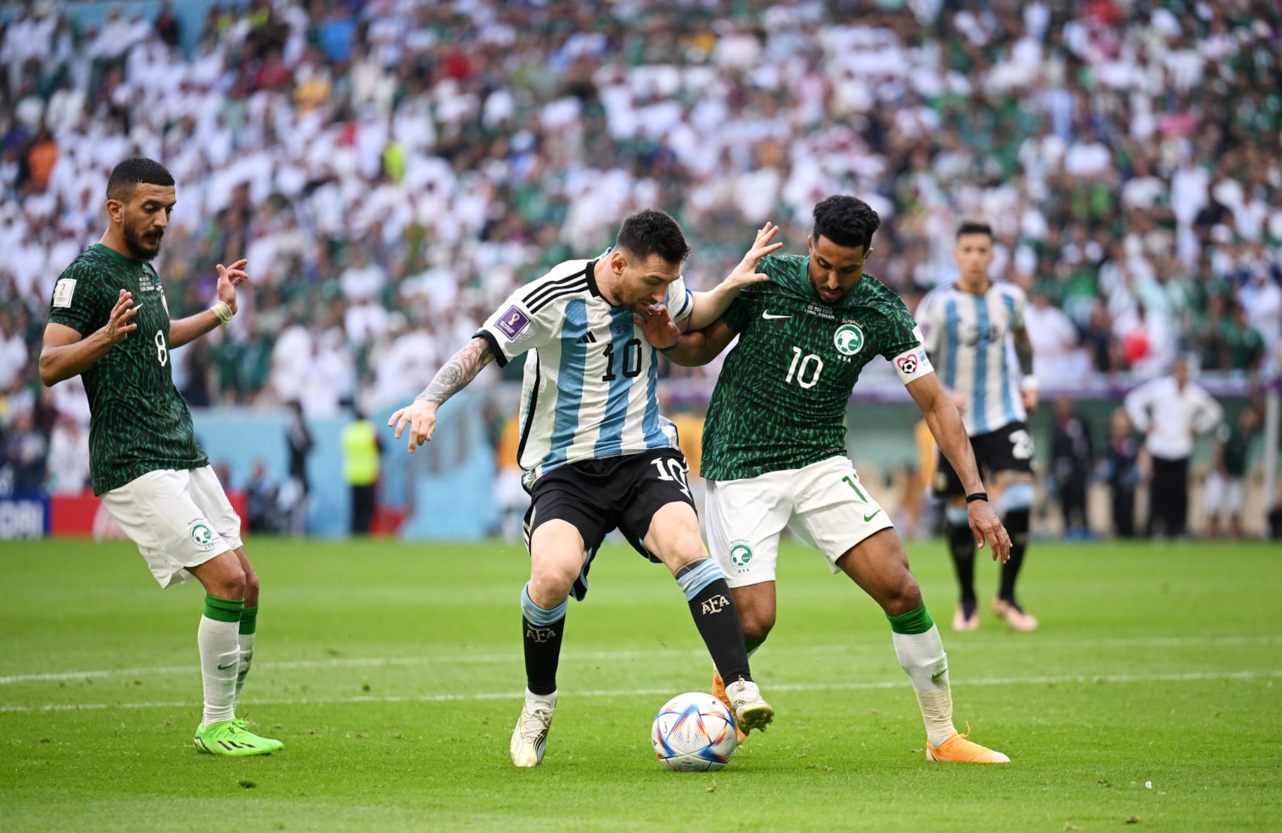 LUSAIL CITY, QATAR - NOVEMBER 22: Lionel Messi of Argentina is challenged by s during the FIFA World Cup Qatar 2022 Group C match between Argentina and Saudi Arabia at Lusail Stadium on November 22, 2022 in Lusail City, Qatar. (Photo by Matthias Hangst/Getty Images) LUSAIL CITY, QATAR - NOVEMBER 22: Lionel Messi of Argentina is challenged by s during the FIFA World Cup Qatar 2022 Group C match between Argentina and Saudi Arabia at Lusail Stadium on November 22, 2022 in Lusail City, Qatar. (Photo by Matthias Hangst/Getty Images)