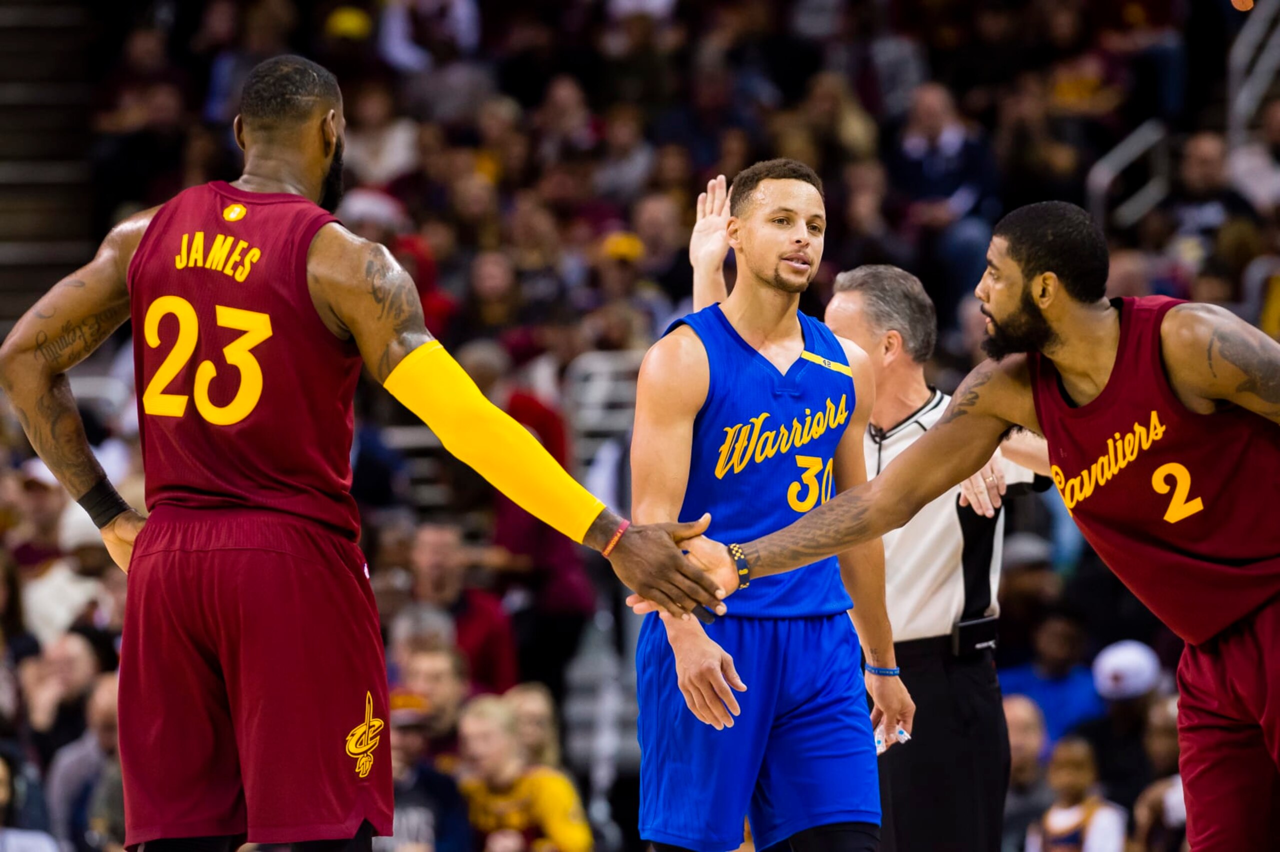 CLEVELAND, OH - DECEMBER 25: Stephen Curry #30 of the Golden State Warriors reacts as LeBron James #23 of the Cleveland Cavaliers and Kyrie Irving #2 celebrate after scoring during the first half at Quicken Loans Arena on December 25, 2016 in Cleveland, Ohio. NOTE TO USER: User expressly acknowledges and agrees that, by downloading and/or using this photograph, user is consenting to the terms and conditions of the Getty Images License Agreement. Mandatory copyright notice. (Photo by Jason Miller/Getty Images)