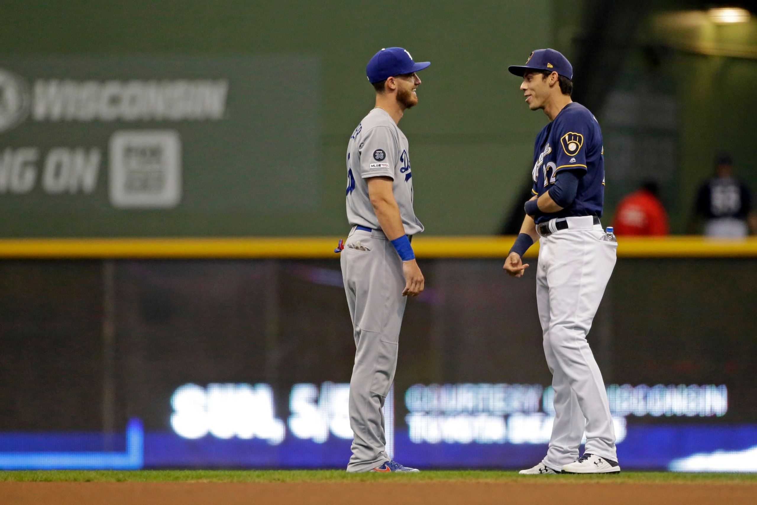 Milwaukee Brewers' Christian Yelich talks with Los Angeles Dodgers' Cody Bellinger before a baseball game Thursday, April 18, 2019, in Milwaukee. (AP Photo/Aaron Gash)
