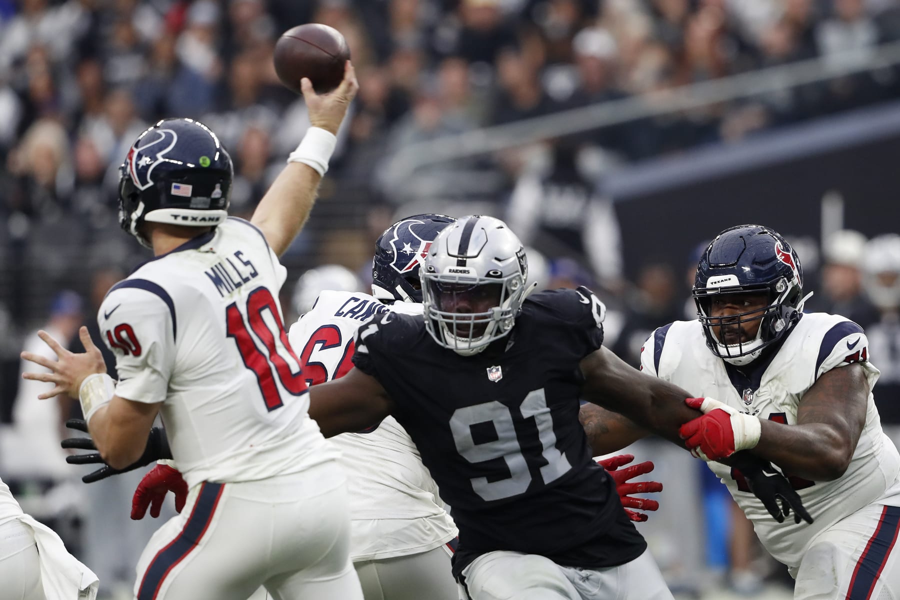 LAS VEGAS, NEVADA - OCTOBER 23: Bilal Nichols #91 of the Las Vegas Raiders puts pressure on Davis Mills #10 of the Houston Texans in the fourth quarter at Allegiant Stadium on October 23, 2022 in Las Vegas, Nevada. (Photo by Steve Marcus/Getty Images)