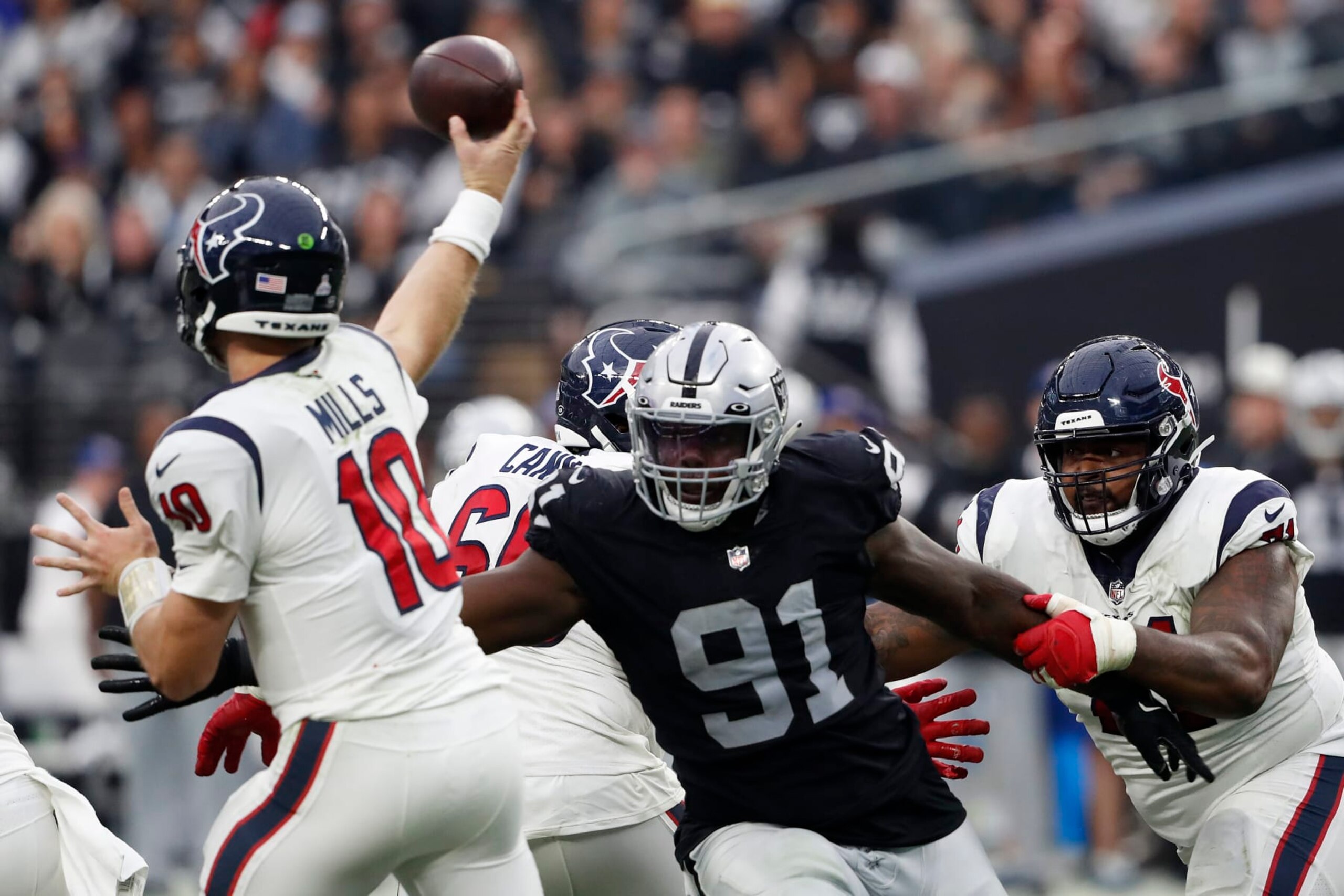 LAS VEGAS, NEVADA - OCTOBER 23: Bilal Nichols #91 of the Las Vegas Raiders puts pressure on Davis Mills #10 of the Houston Texans in the fourth quarter at Allegiant Stadium on October 23, 2022 in Las Vegas, Nevada. (Photo by Steve Marcus/Getty Images)
