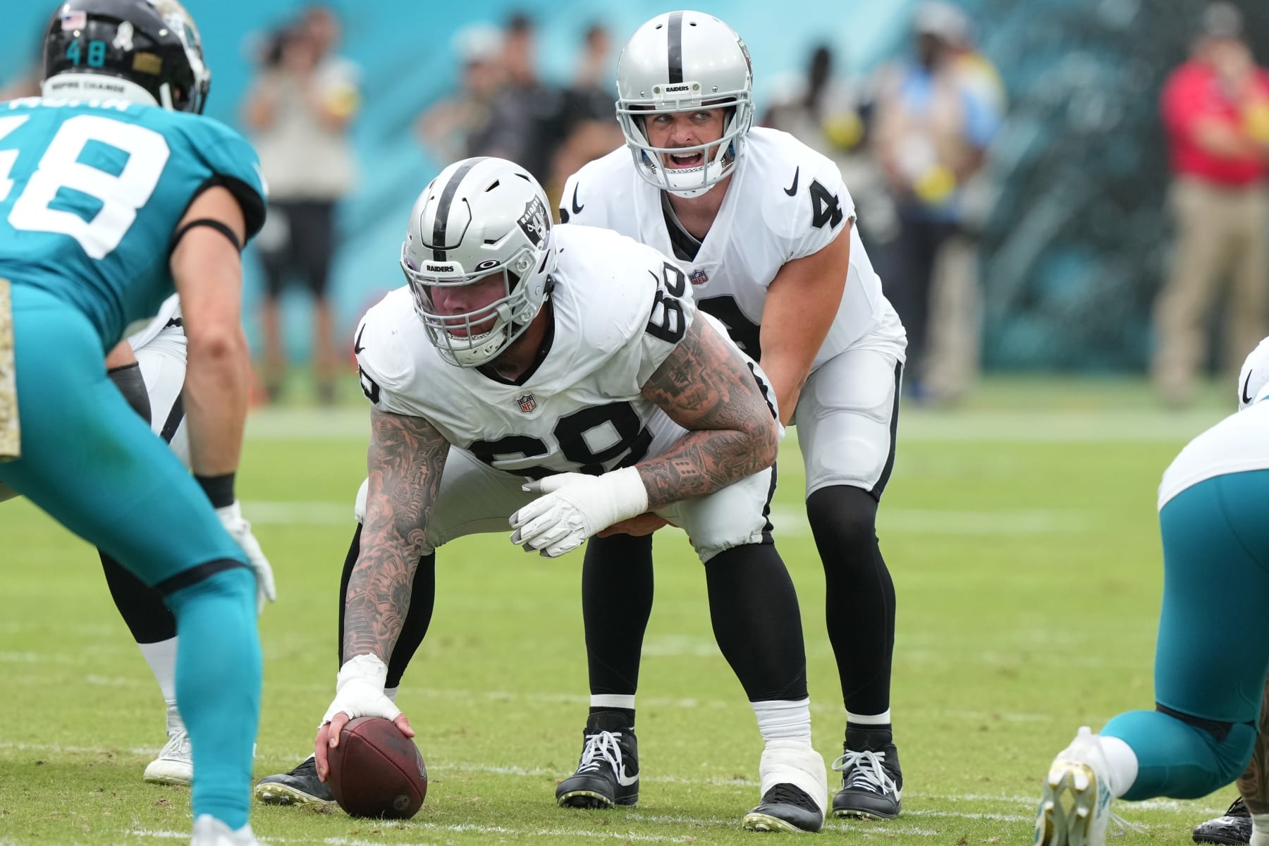 JACKSONVILLE, FLORIDA - NOVEMBER 06: Derek Carr #4 of the Las Vegas Raiders	calls the play as Andre James #68 of the Las Vegas Raiders holds the ball during the second quarter of the game against the Jacksonville Jaguars at TIAA Bank Field on November 06, 2022 in Jacksonville, Florida. (Photo by Eric Espada/Getty Images)