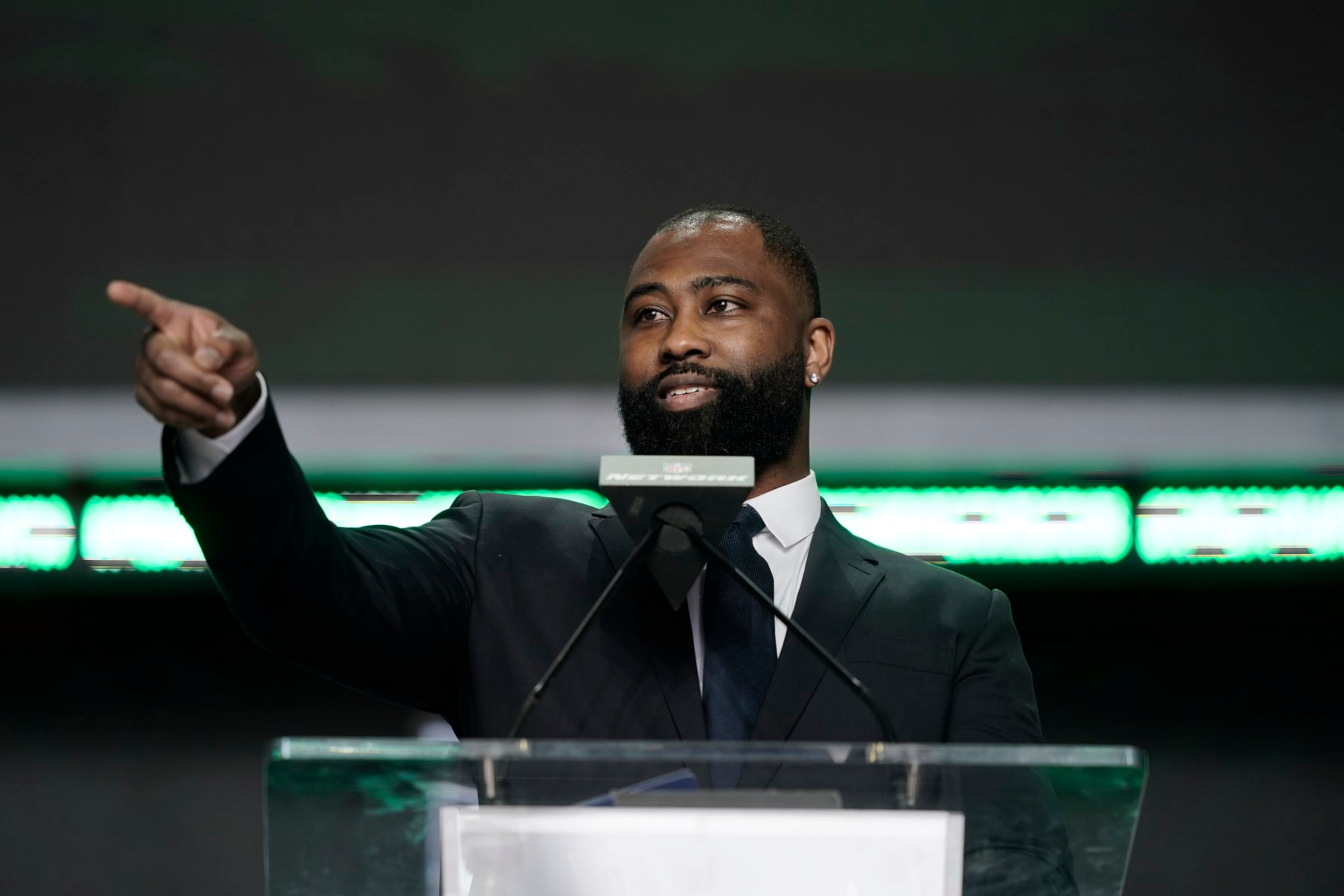 Darrelle Revis announces Iowa state running back Breece Hall as the New York Jets selection during the second round of the NFL football draft Friday, April 29, 2022, in Las Vegas. (AP Photo/Jae C. Hong)