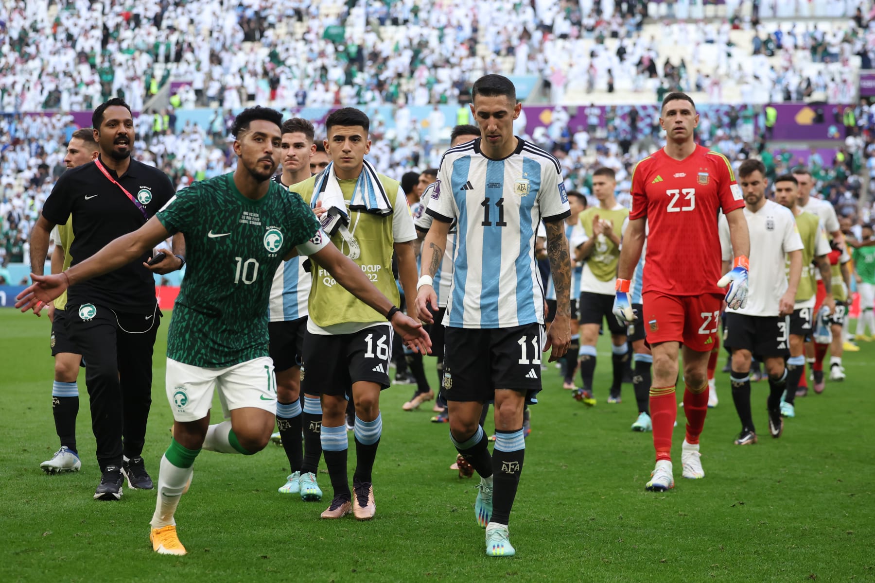 LUSAIL CITY, QATAR - NOVEMBER 22: Salem Al-Dawsari of Saudi Arabia celebrates victory while Angel Di Maria of Argentina shows dejection after the FIFA World Cup Qatar 2022 Group C match between Argentina and Saudi Arabia at Lusail Stadium on November 22, 2022 in Lusail City, Qatar. (Photo by Hector Vivas - FIFA/FIFA via Getty Images)