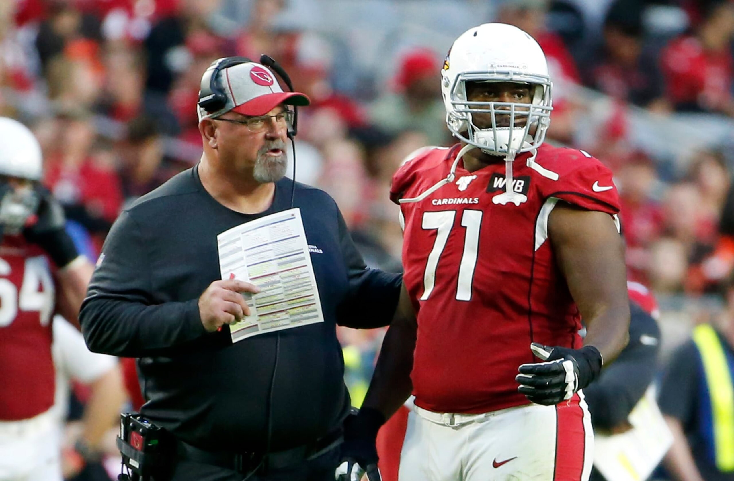 GLENDALE, ARIZONA - DECEMBER 15: Offensive lineman Justin Murray #71 of the Arizona Cardinals with offensive line coach Sean Kugler during the second half of the NFL football game against the Cleveland Browns at State Farm Stadium on December 15, 2019 in Glendale, Arizona. (Photo by Ralph Freso/Getty Images) GLENDALE, ARIZONA - DECEMBER 15: Offensive lineman Justin Murray #71 of the Arizona Cardinals with offensive line coach Sean Kugler during the second half of the NFL football game against the Cleveland Browns at State Farm Stadium on December 15, 2019 in Glendale, Arizona. (Photo by Ralph Freso/Getty Images)