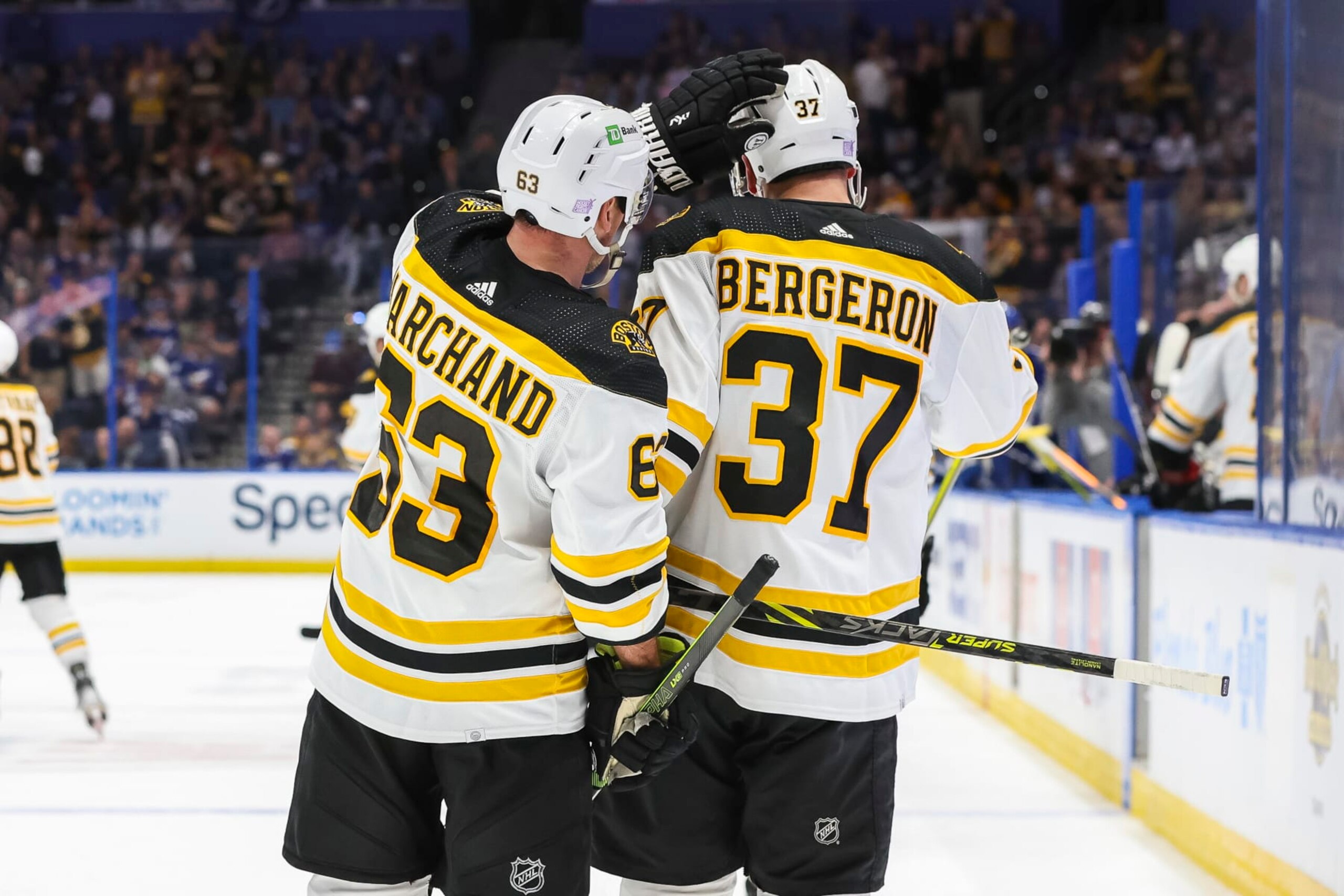TAMPA, FL - NOVEMBER 21: Patrice Bergeron #37 and Brad Marchand #63 of the Boston Bruins celebrate a goal against the Tampa Bay Lightning and Bergerons 1000th career NHL point during the second period at Amalie Arena on November 21, 2022 in Tampa, Florida. (Photo by Mike Carlson/NHLI via Getty Images)