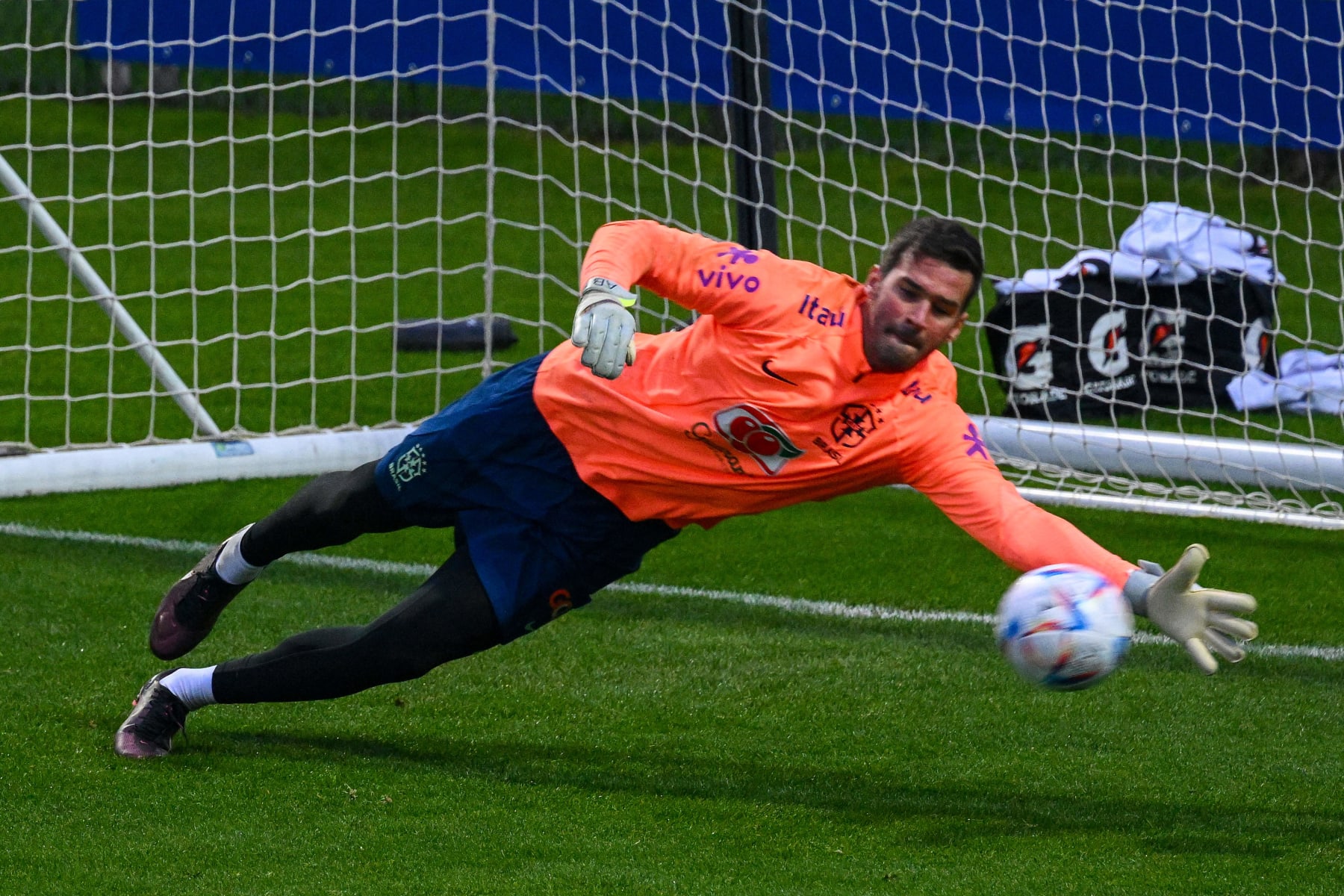 Brazil's goalkeeper Alisson deflects a shot during a training session on November 14, 2022 at the Continassa training ground in Turin, northern Italy, as part of Brazil's national football team preparation ahead of the Qatar 2022 World Cup. - The week-long countdown to the World Cup in Qatar begins as the world's leading footballers focused their attention on one of the most controversial tournaments in history. The first World Cup to be held in the Arab world will kick off on November 20, 2022, when the host nation face Ecuador. (Photo by Vincenzo PINTO / AFP) (Photo by VINCENZO PINTO/AFP via Getty Images)