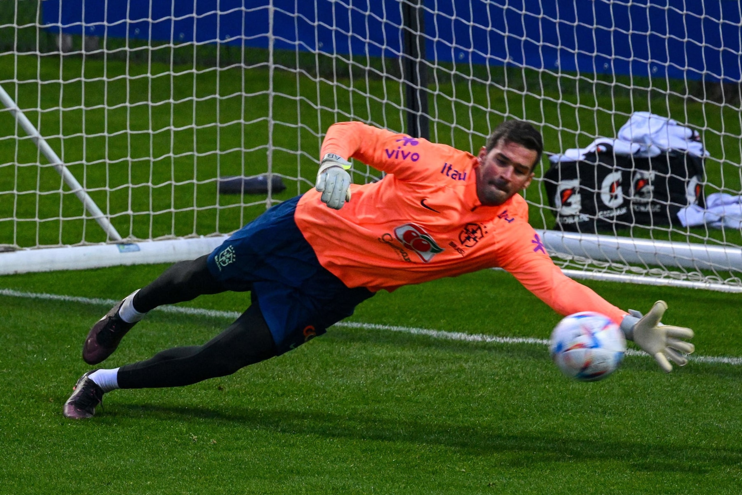 Brazil's goalkeeper Alisson deflects a shot during a training session on November 14, 2022 at the Continassa training ground in Turin, northern Italy, as part of Brazil's national football team preparation ahead of the Qatar 2022 World Cup. - The week-long countdown to the World Cup in Qatar begins as the world's leading footballers focused their attention on one of the most controversial tournaments in history. The first World Cup to be held in the Arab world will kick off on November 20, 2022, when the host nation face Ecuador. (Photo by Vincenzo PINTO / AFP) (Photo by VINCENZO PINTO/AFP via Getty Images)