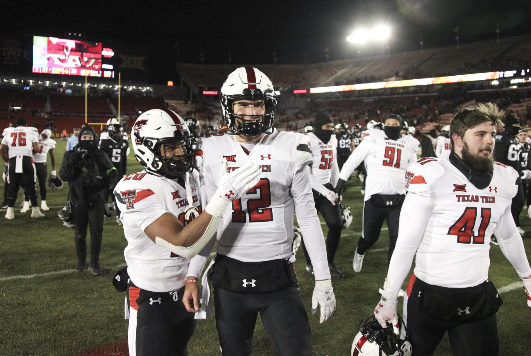 AMES, IOWA- NOVEMBER 19:  Quarterback Tyler Shough #12 of the Texas Tech Red Raiders celebrates with wide receiver Nehemiah Martinez #20 after the match-up against the Iowa State Cyclones at Jack Trice Stadium, on November 19, 2022 in Ames, Iowa.  (Photo by Matthew Holst/Getty Images)