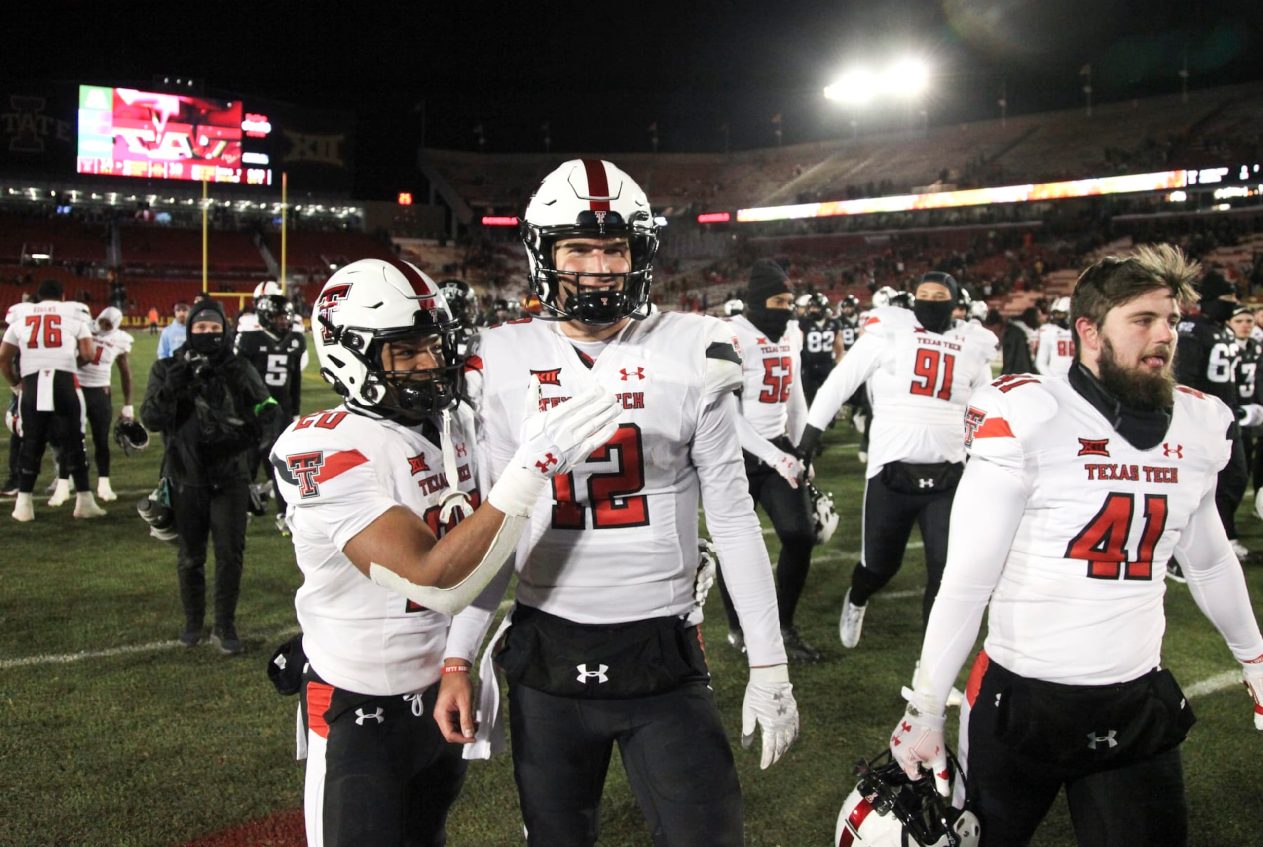 AMES, IOWA- NOVEMBER 19:  Quarterback Tyler Shough #12 of the Texas Tech Red Raiders celebrates with wide receiver Nehemiah Martinez #20 after the match-up against the Iowa State Cyclones at Jack Trice Stadium, on November 19, 2022 in Ames, Iowa.  (Photo by Matthew Holst/Getty Images)