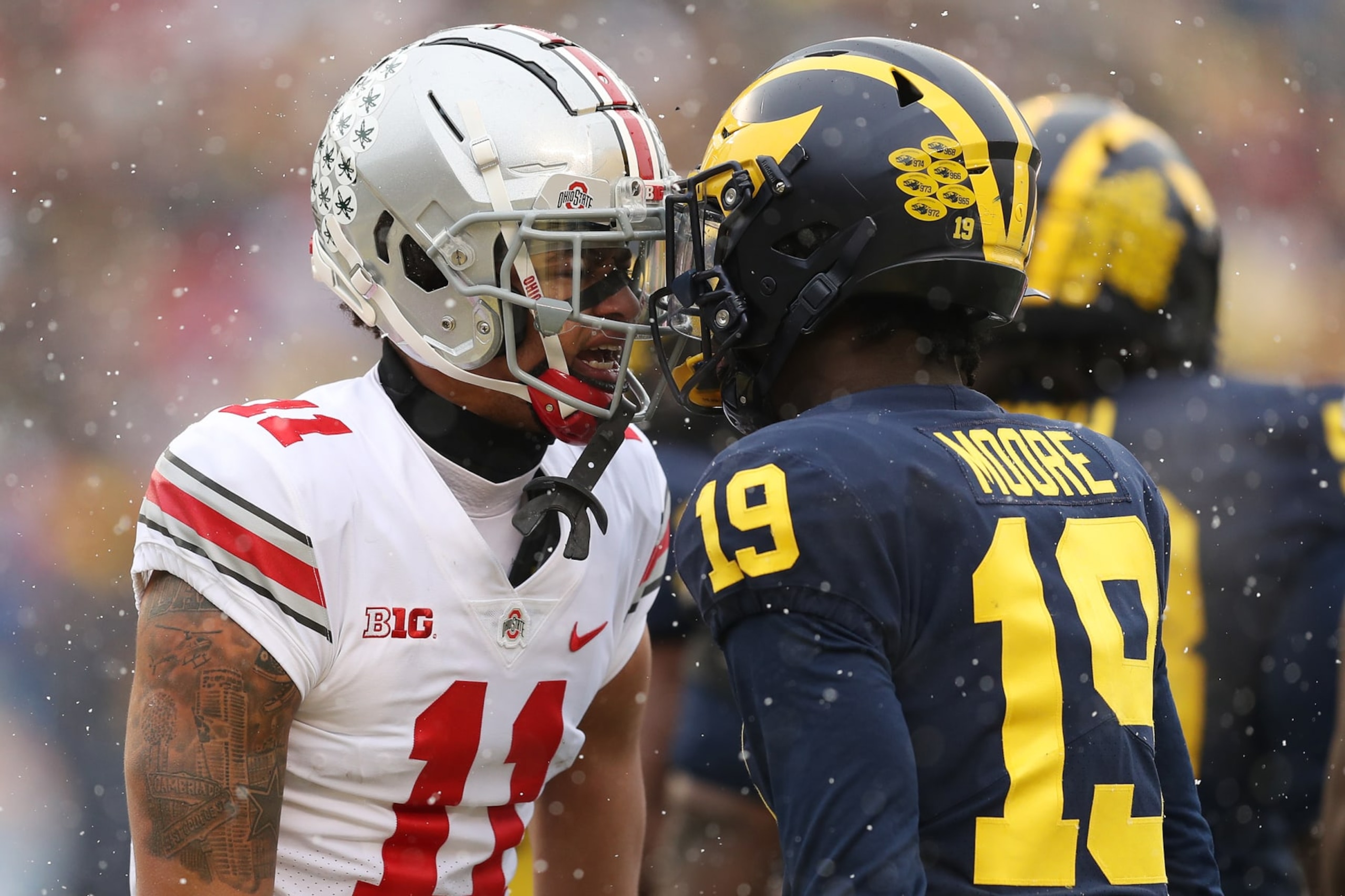 ANN ARBOR, MICHIGAN - NOVEMBER 27: Jaxon Smith-Njigba #11 of the Ohio State Buckeyes and Rod Moore #19 of the Michigan Wolverines talk during the first quarter at Michigan Stadium on November 27, 2021 in Ann Arbor, Michigan. (Photo by Mike Mulholland/Getty Images) ANN ARBOR, MICHIGAN - NOVEMBER 27: Jaxon Smith-Njigba #11 of the Ohio State Buckeyes and Rod Moore #19 of the Michigan Wolverines talk during the first quarter at Michigan Stadium on November 27, 2021 in Ann Arbor, Michigan. (Photo by Mike Mulholland/Getty Images)