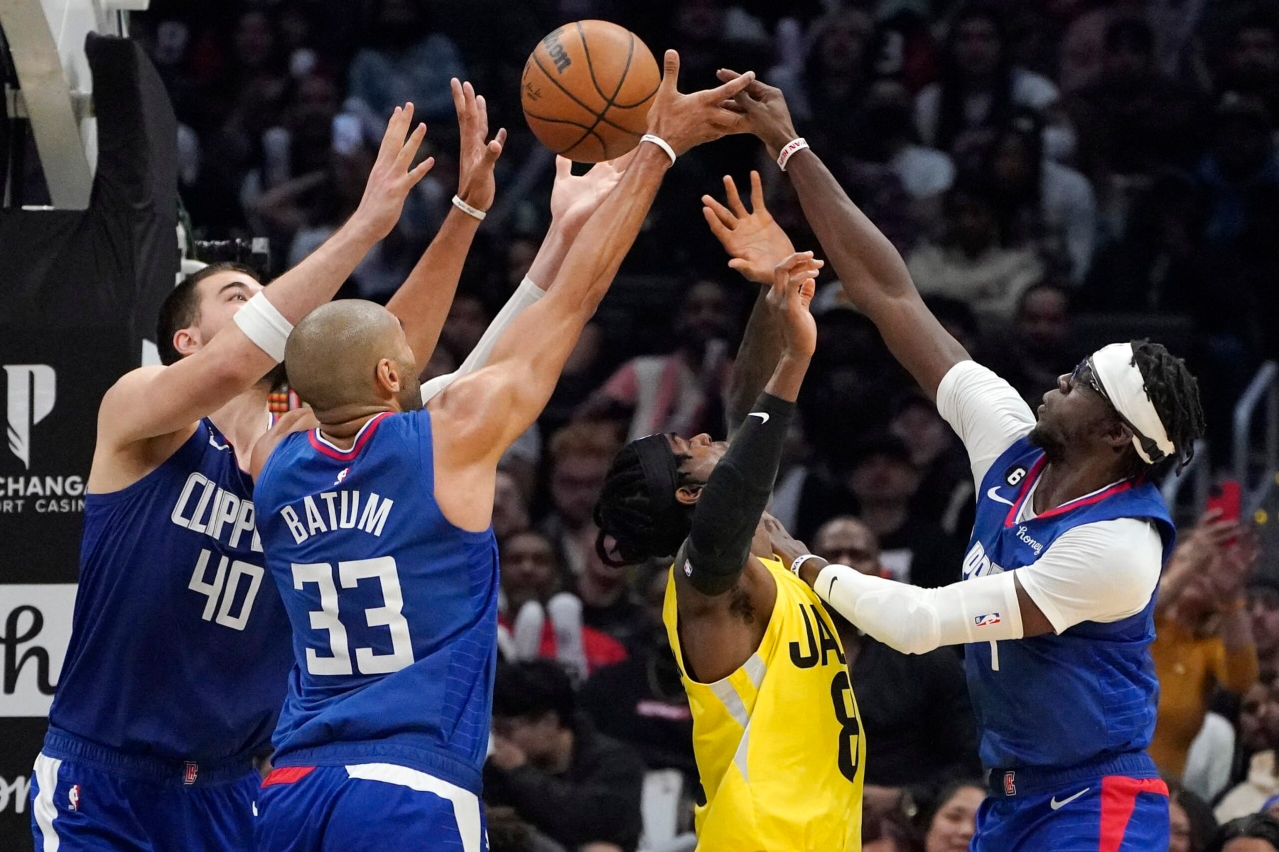 Los Angeles Clippers center Ivica Zubac (40), forward Nicolas Batum (33) and guard Reggie Jackson (1) go after a rebound along with Utah Jazz forward Jarred Vanderbilt (8) during the second half of an NBA basketball game Monday, Nov. 21, 2022, in Los Angeles. (AP Photo/Mark J. Terrill)