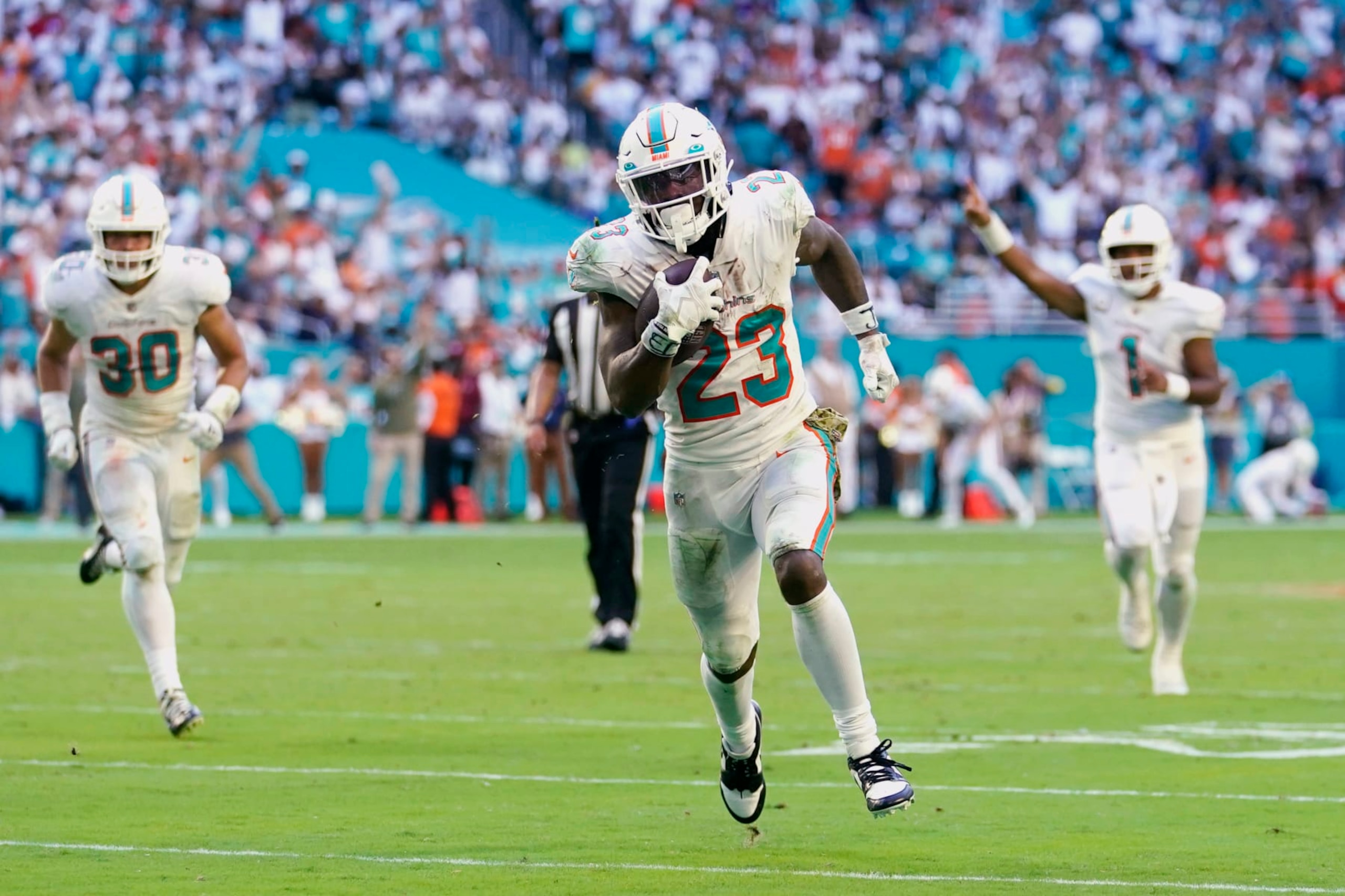 Miami Dolphins running back Jeff Wilson Jr. (23) runs for a touchdown during the second half of an NFL football game against the Cleveland Browns, Sunday, Nov. 13, 2022, in Miami Gardens, Fla. (AP Photo/Lynne Sladky) Miami Dolphins running back Jeff Wilson Jr. (23) runs for a touchdown during the second half of an NFL football game against the Cleveland Browns, Sunday, Nov. 13, 2022, in Miami Gardens, Fla. (AP Photo/Lynne Sladky)