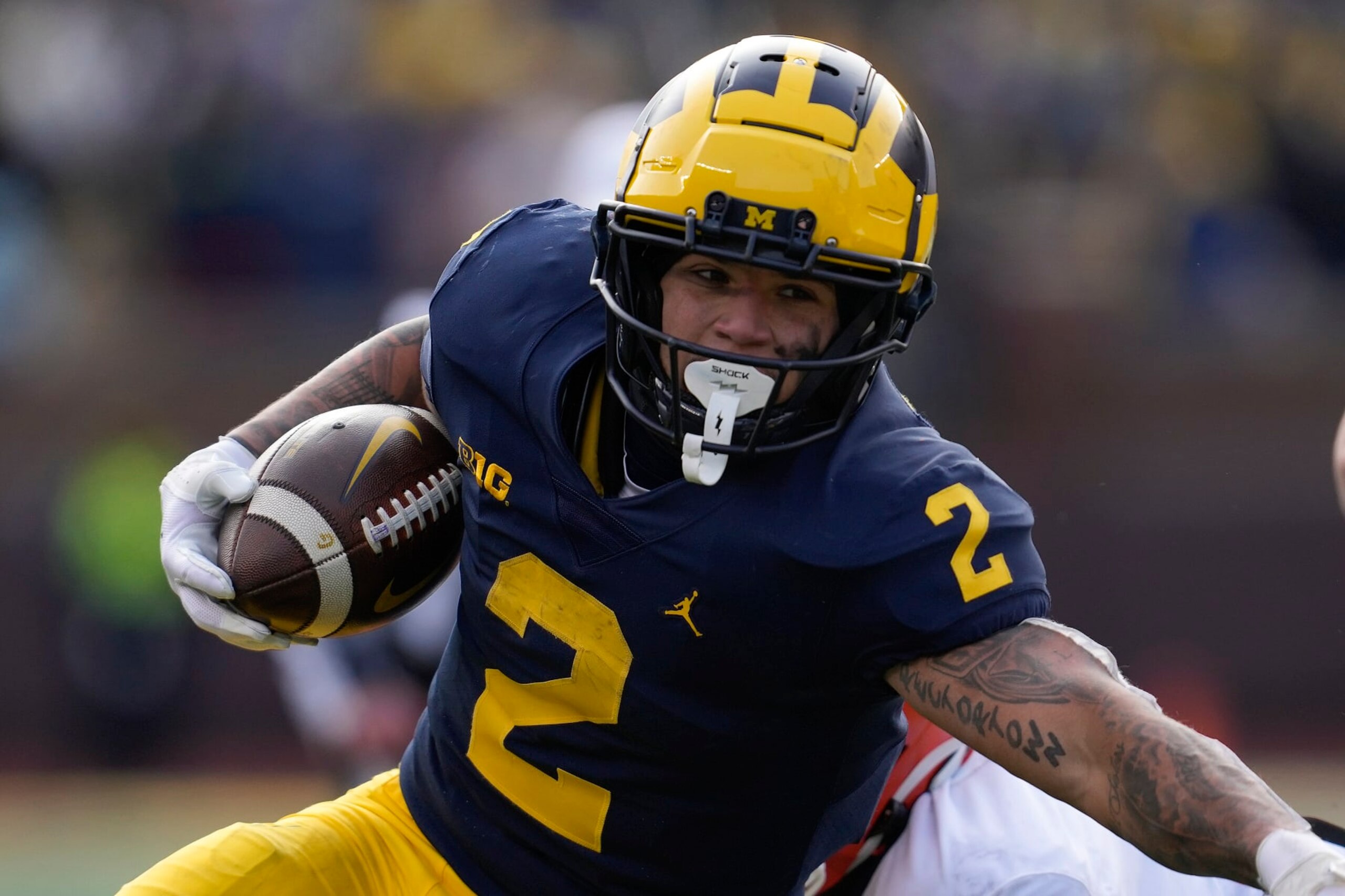 Michigan running back Blake Corum (2) runs the ball against Illinois in the first half of an NCAA college football game in Ann Arbor, Mich., Saturday, Nov. 19, 2022. (AP Photo/Paul Sancya)