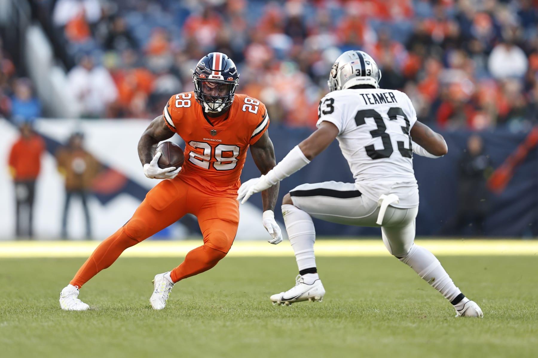 DENVER, COLORADO - NOVEMBER 20: Latavius Murray #28 of the Denver Broncos runs against Roderic Teamer #33 of the Las Vegas Raiders during an NFL game between the Las Vegas Raiders and Denver Broncos at Empower Field At Mile High on November 20, 2022 in Denver, Colorado. The Las Vegas Raiders won in overtime (Photo by Michael Owens/Getty Images)