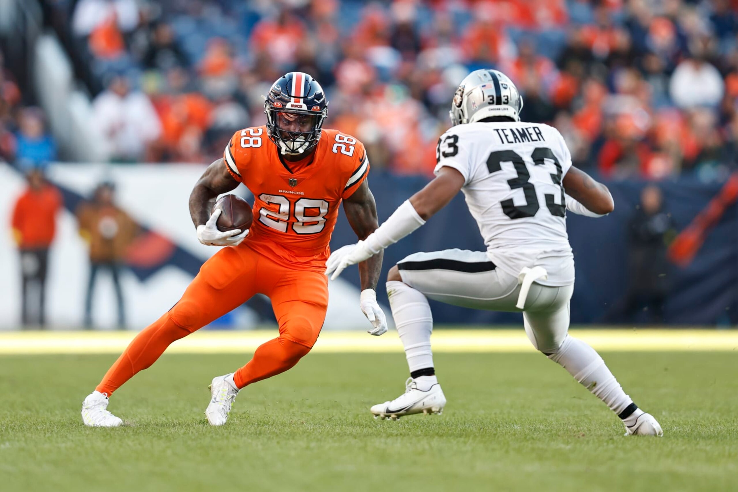 DENVER, COLORADO - NOVEMBER 20: Latavius Murray #28 of the Denver Broncos runs against Roderic Teamer #33 of the Las Vegas Raiders during an NFL game between the Las Vegas Raiders and Denver Broncos at Empower Field At Mile High on November 20, 2022 in Denver, Colorado. The Las Vegas Raiders won in overtime (Photo by Michael Owens/Getty Images)