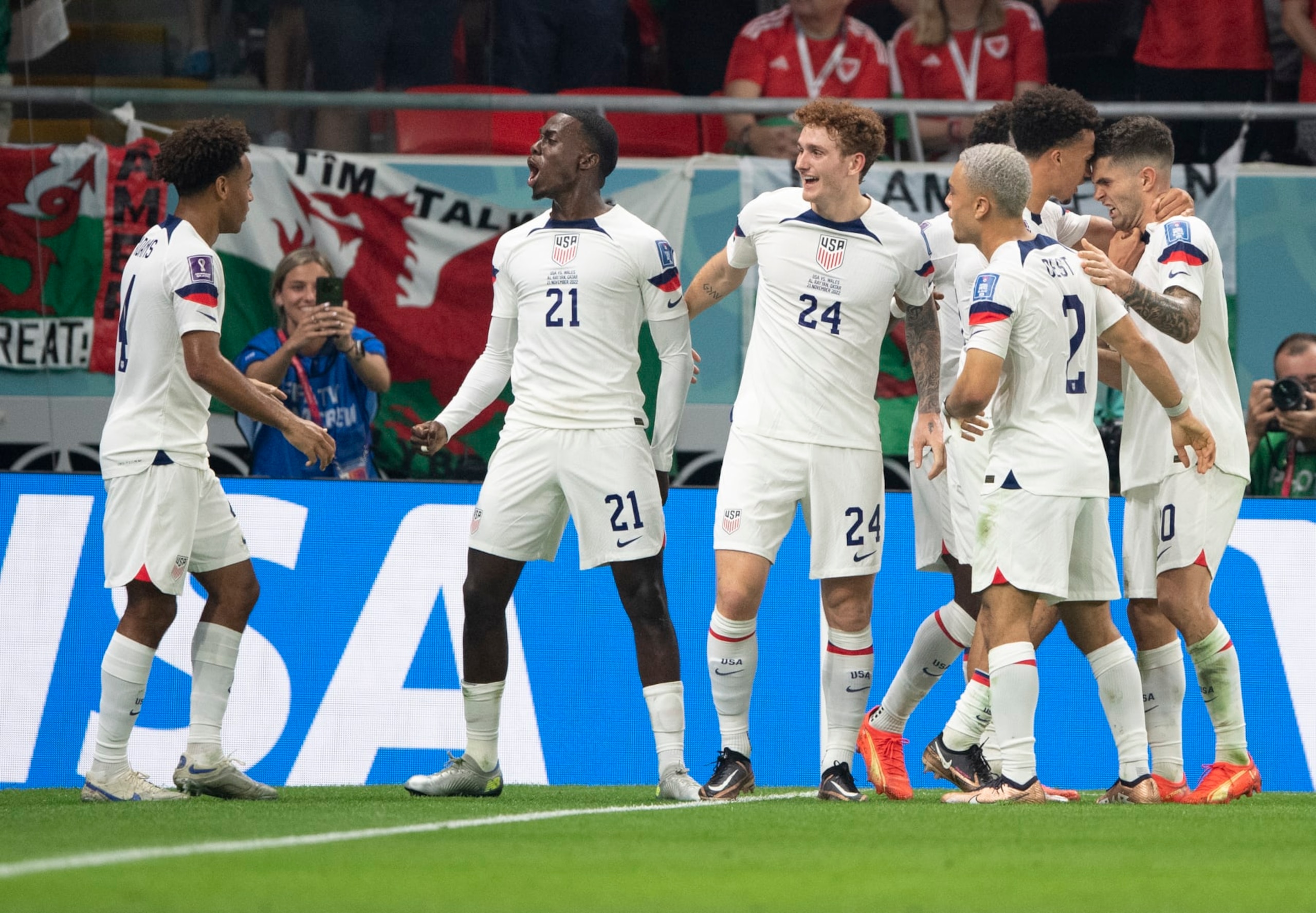 DOHA, QATAR - NOVEMBER 21: Timothy Weah of USA celebrates scoring with team mates Tyler Adams, Joshua Sargent, Antonee Robinson, Sergino Dest and Christian Pulisic during the FIFA World Cup Qatar 2022 Group B match between USA and Wales at Ahmad Bin Ali Stadium on November 21, 2022 in Doha, Qatar. (Photo by Visionhaus/Getty Images) DOHA, QATAR - NOVEMBER 21: Timothy Weah of USA celebrates scoring with team mates Tyler Adams, Joshua Sargent, Antonee Robinson, Sergino Dest and Christian Pulisic during the FIFA World Cup Qatar 2022 Group B match between USA and Wales at Ahmad Bin Ali Stadium on November 21, 2022 in Doha, Qatar. (Photo by Visionhaus/Getty Images)