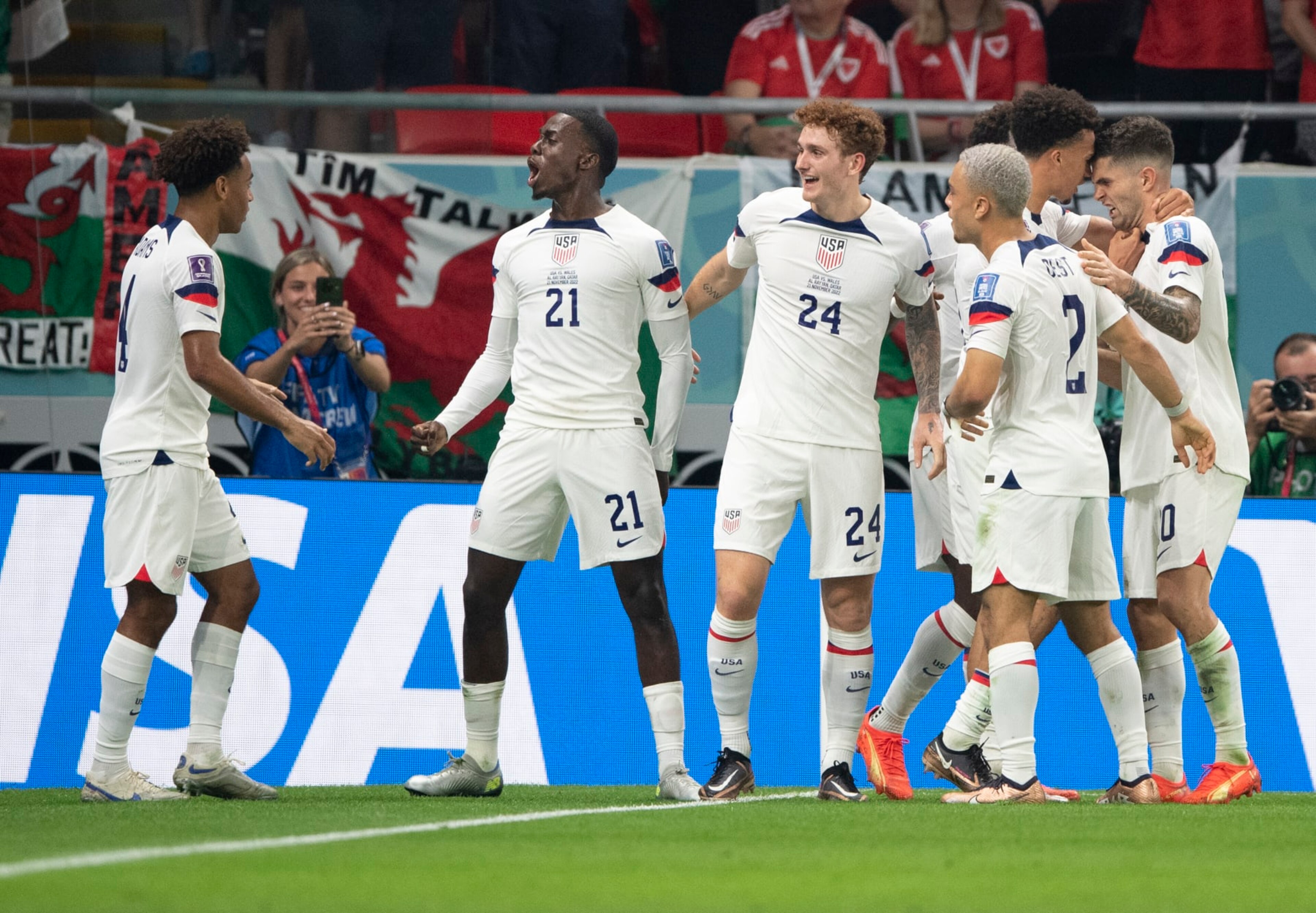 DOHA, QATAR - NOVEMBER 21: Timothy Weah of USA celebrates scoring with team mates Tyler Adams, Joshua Sargent, Antonee Robinson, Sergino Dest and Christian Pulisic during the FIFA World Cup Qatar 2022 Group B match between USA and Wales at Ahmad Bin Ali Stadium on November 21, 2022 in Doha, Qatar. (Photo by Visionhaus/Getty Images)