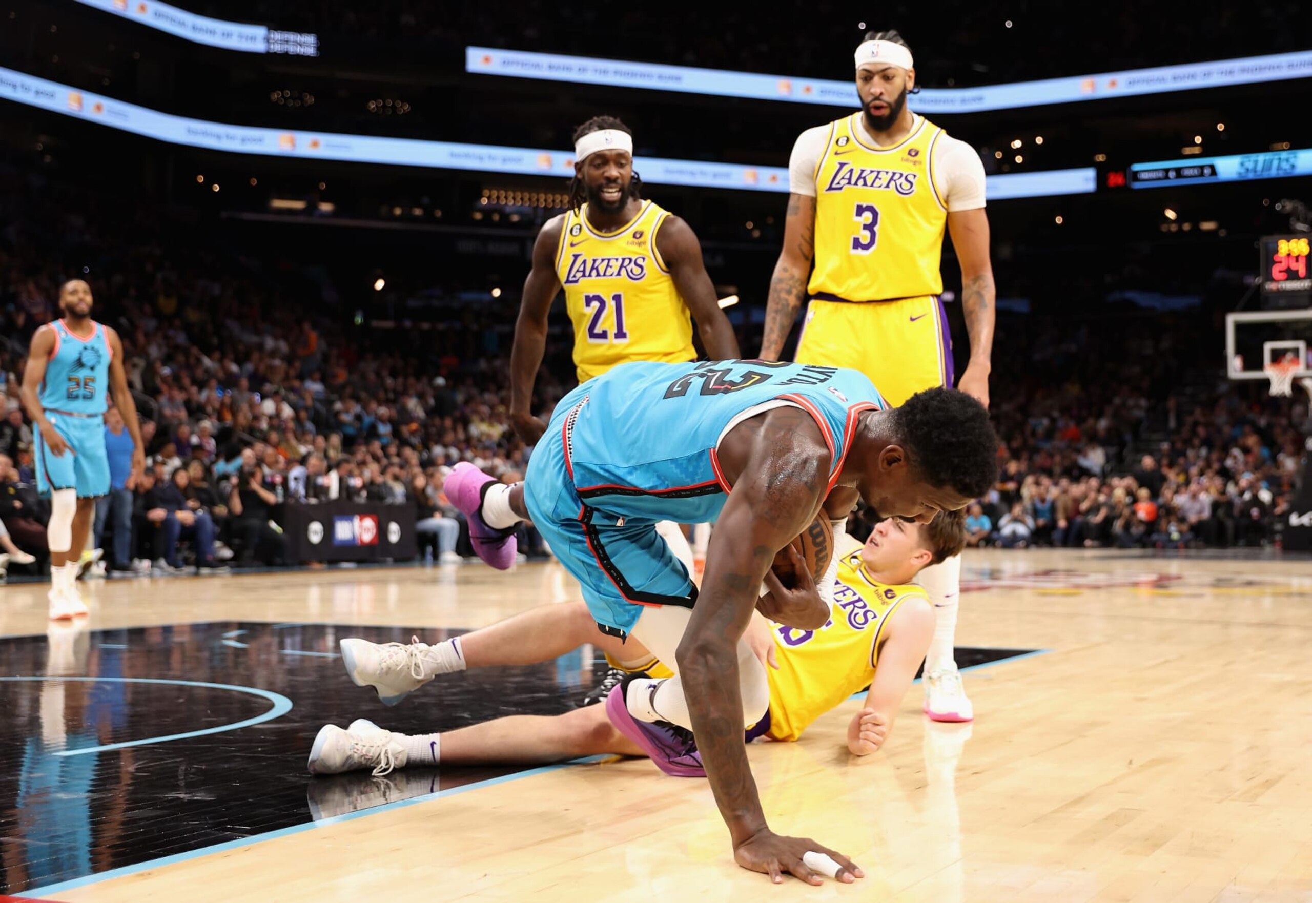 PHOENIX, ARIZONA - NOVEMBER 22: Deandre Ayton #22 of the Phoenix Suns falls over Austin Reaves #15 of the Los Angles Lakers after being pushed by Patrick Beverley #21during the second half of the NBA game at Footprint Center on November 22, 2022 in Phoenix, Arizona. Beverley was ejected on the play. The Suns defeated the Lakers 115-105. NOTE TO USER: User expressly acknowledges and agrees that, by downloading and or using this photograph, User is consenting to the terms and conditions of the Getty Images License Agreement.  (Photo by Christian Petersen/Getty Images)